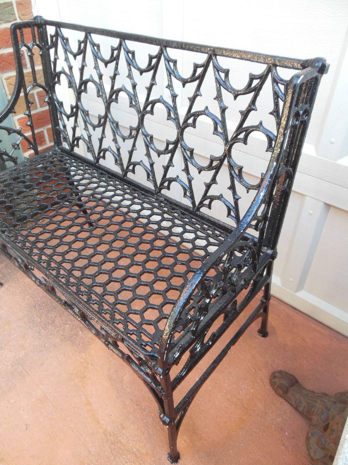 Cast iron Gothic pattern garden bench, mid-19th century decorated with a trefoil and quatrefoil reticulated back. An identical bench in size and design is placed outside the Gothic Revival library in the American wing of the Metropolitan Museum of