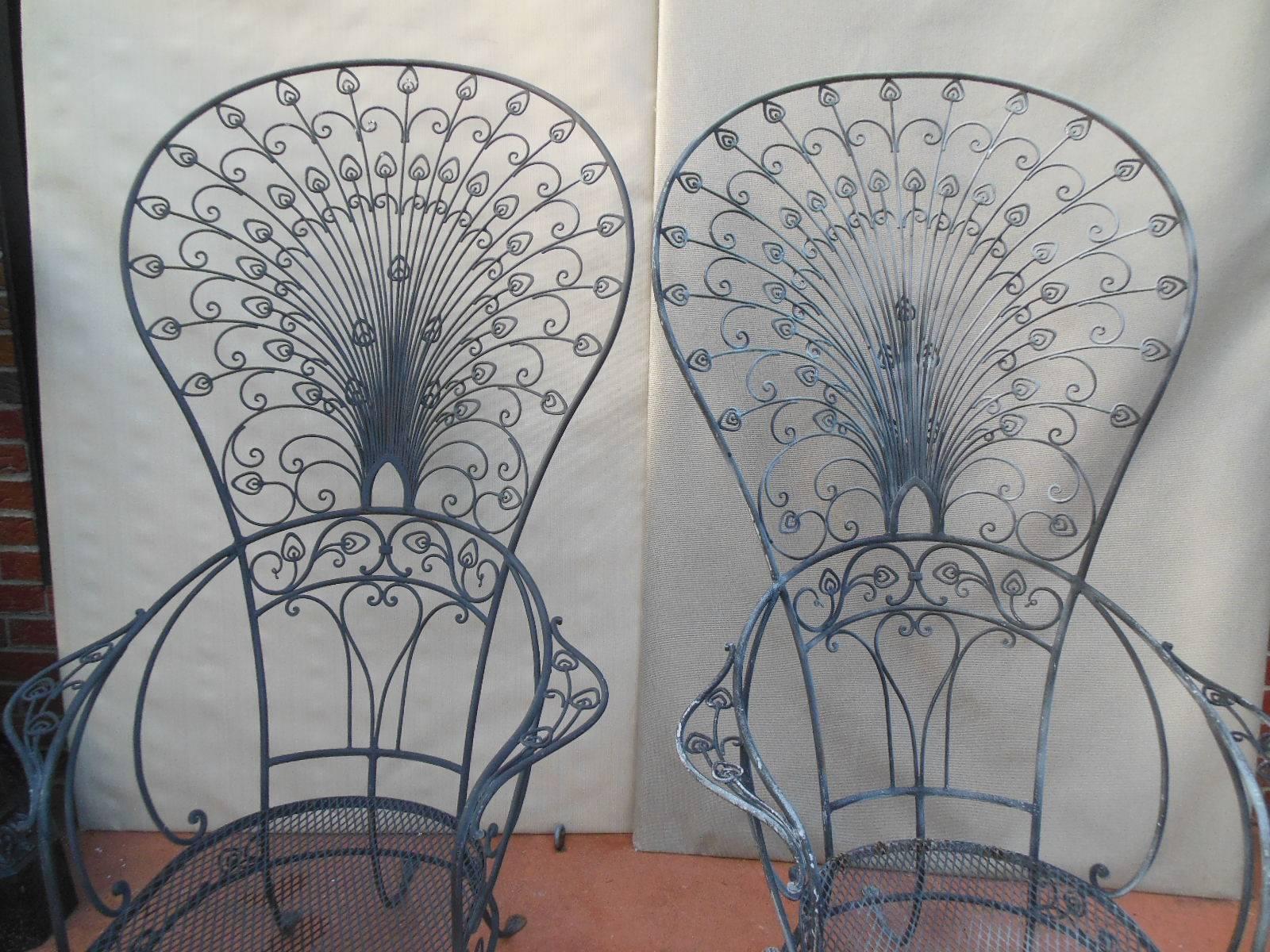 A pair of wrought iron Peacock Chairs by John Salterini. These elaborate wrought iron chairs are the best example of the craftsmanship of Salterini who was the premier manufacturer of wrought iron furniture in New York City in the 2nd quarter of the