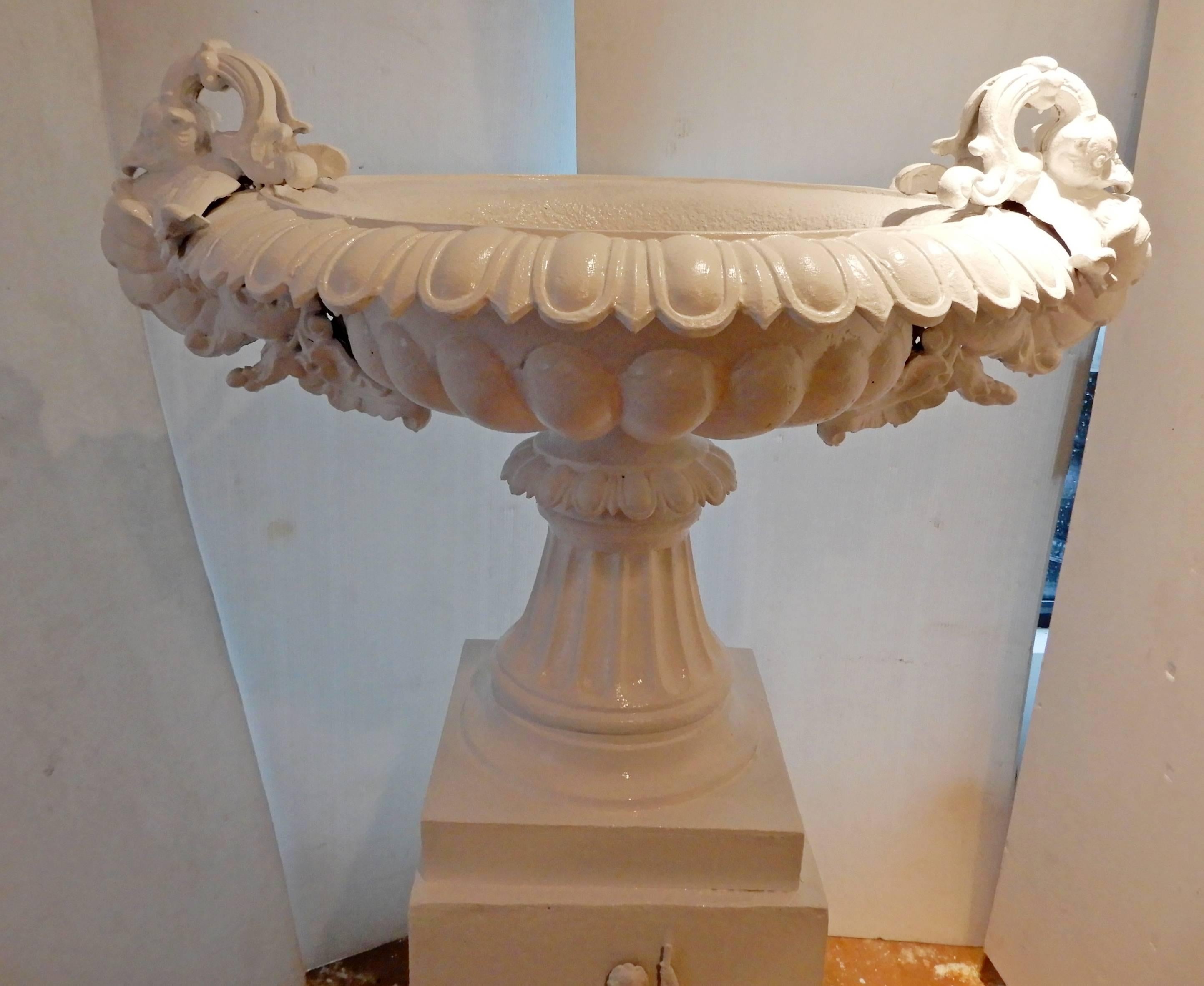 This is an ornate 19th century cast iron garden urn. This distinctive 5 foot tall Victorian garden urn is similar to signed Fiske urns previously in inventory. The urn is in mint condition and extremely heavy to move. There are four different