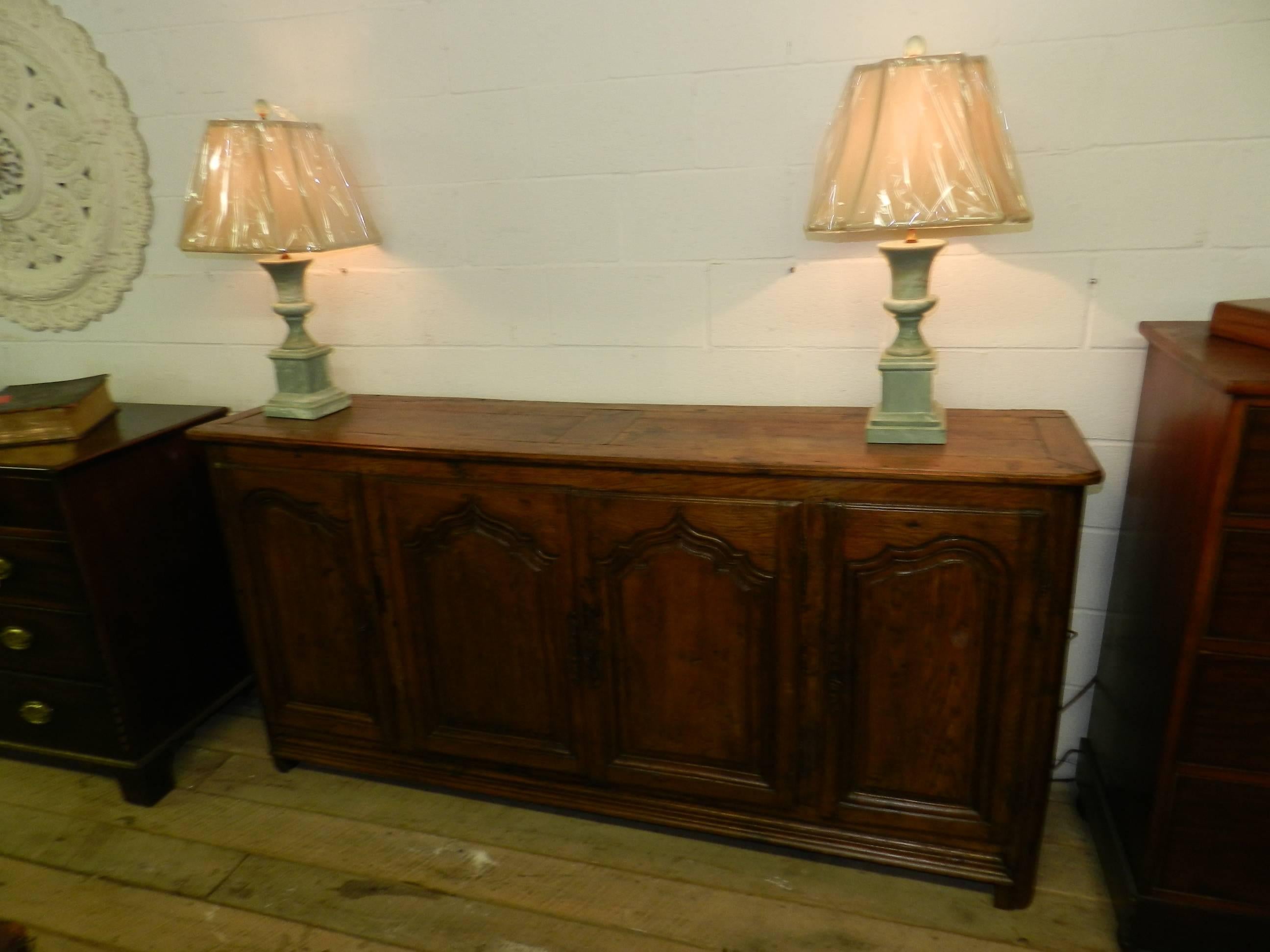 Antique French solid oak buffet with four-panel doors and paneled sides.