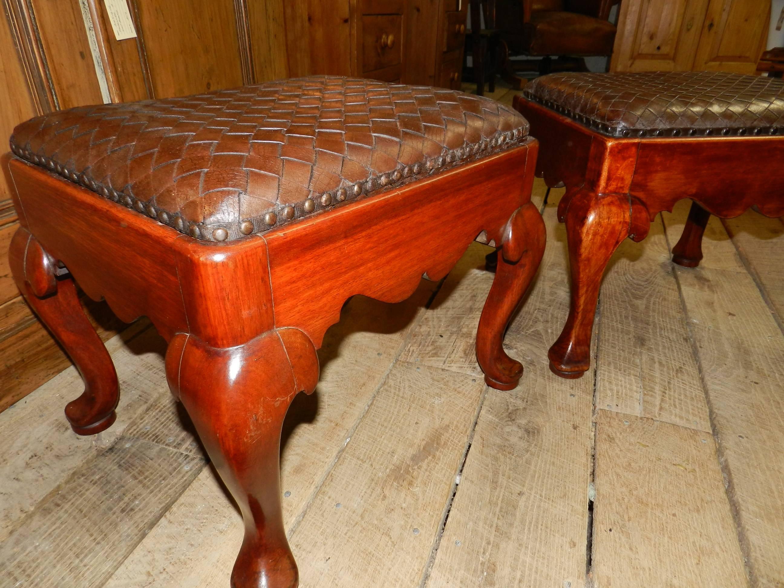 Pair of mahogany framed Chippendale style stools with woven leather seats.