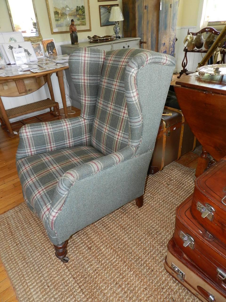 Antique wing chair with turned legs. This chair has been fully refurbished and covered with tweed from Abraham Moon, Yorkshire, England.