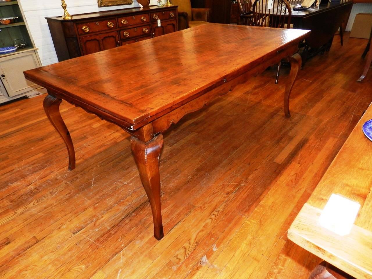 A handmade cherry dining table with two draw leaves giving complete versatility. The table is six foot when both draw leaves are easily slid underneath the table and when leaves are fully out the table extends to ten foot. By easing the top of the