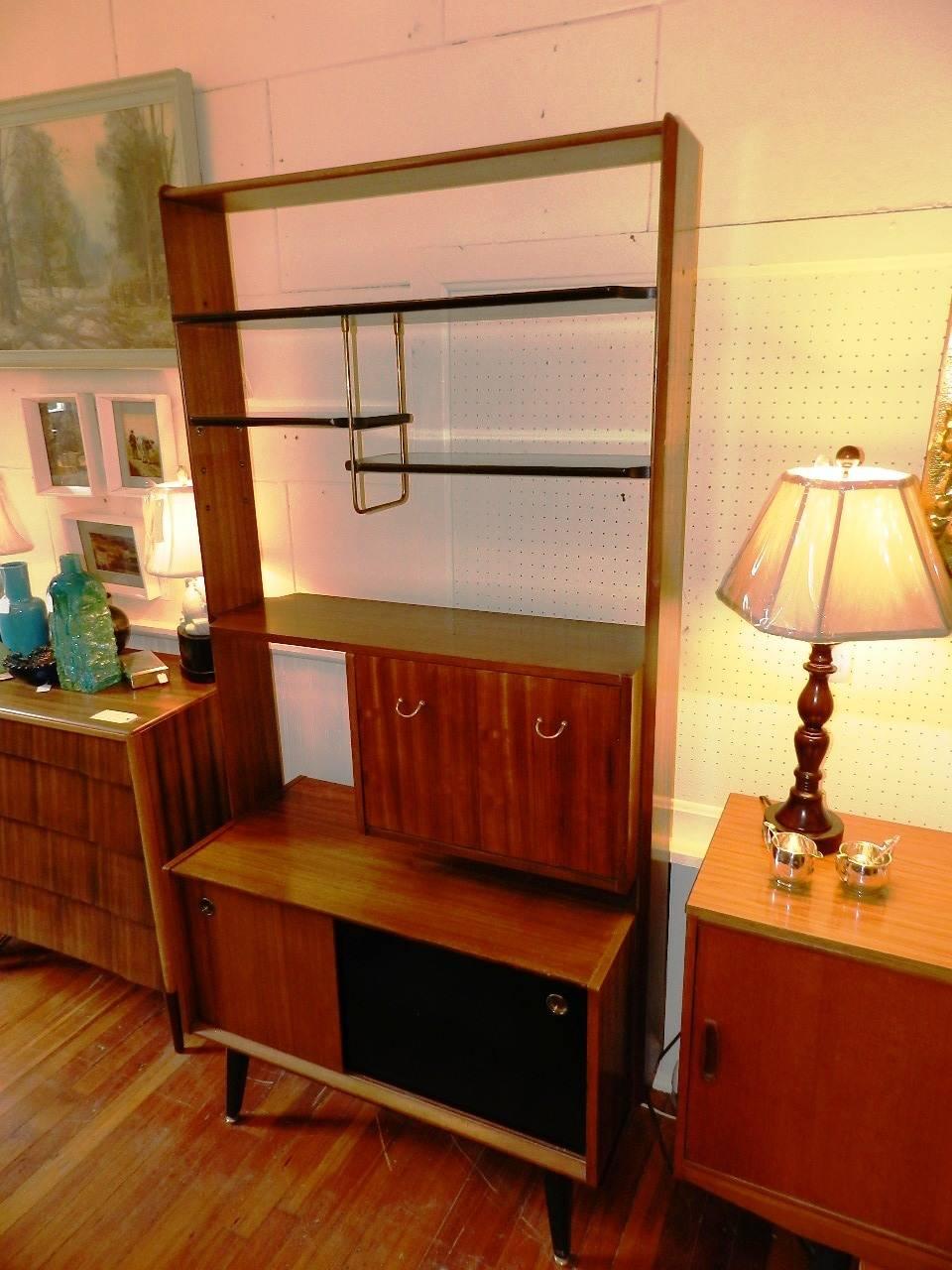 1970s teak display shelves and room divider with finished back and fall front desk with sliding cupboard doors below. The upper display shelves are adjustable.