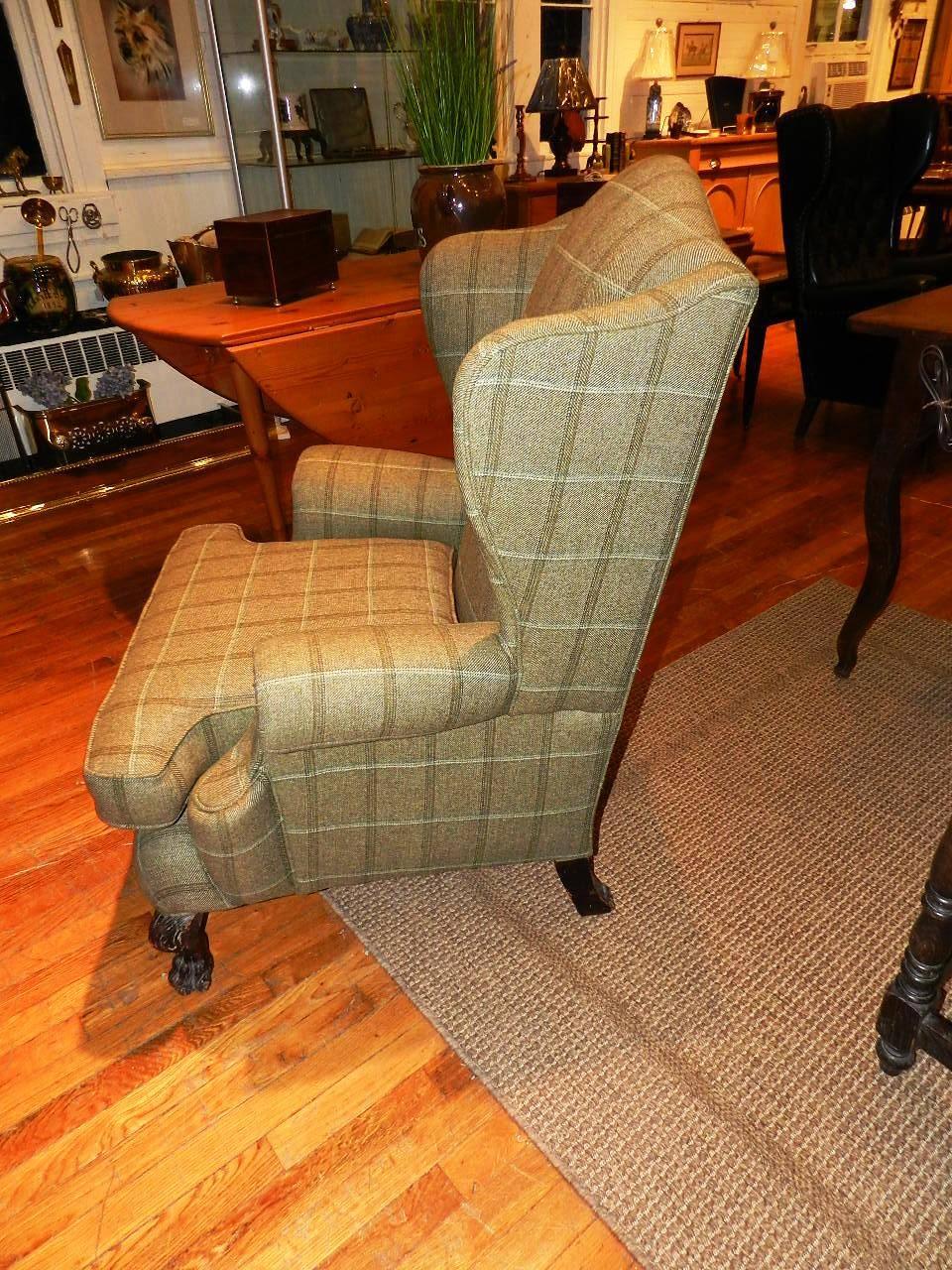 Antique wing chair with mahogany carved legs, out swept arms and a shaped cushion. This armchair has been recently professionally upholstered in wool tweed by Abraham Moon, Yorkshire, England.