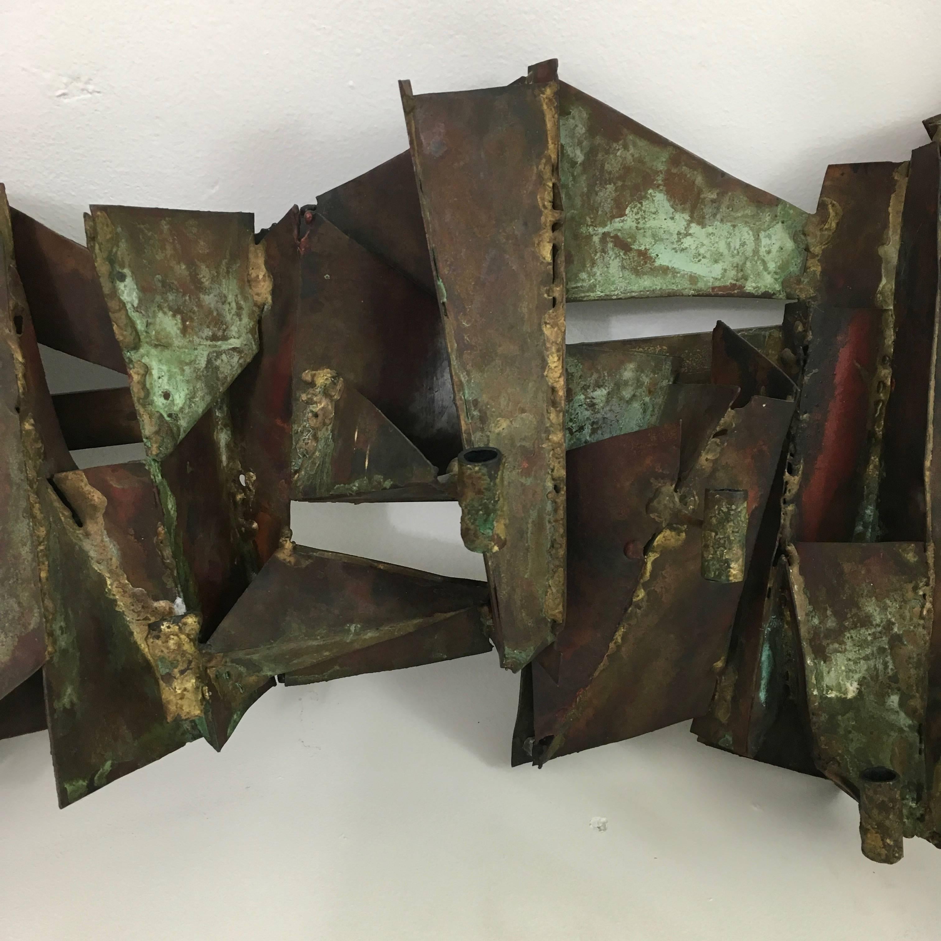 A unique wall mounted copper wall candelabra. 
Signed on verso with accompanying provenance.