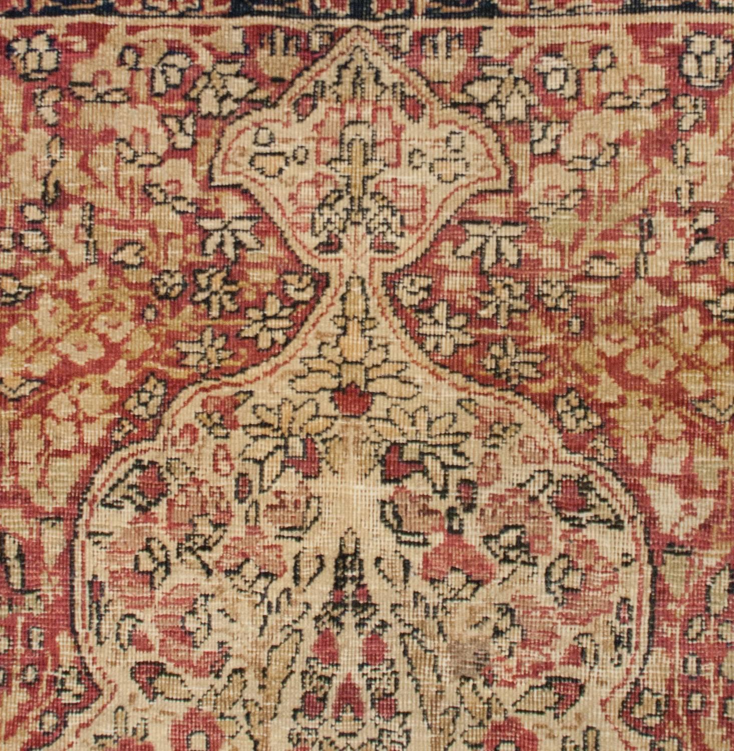 A wonderful late 19th century Persian Lavar Kirman prayer rug with a beautiful pattern of multiple flowering trees and branches woven in traditional cranberry, pink, cream and black wool. The border is comprised of three distinct floral and