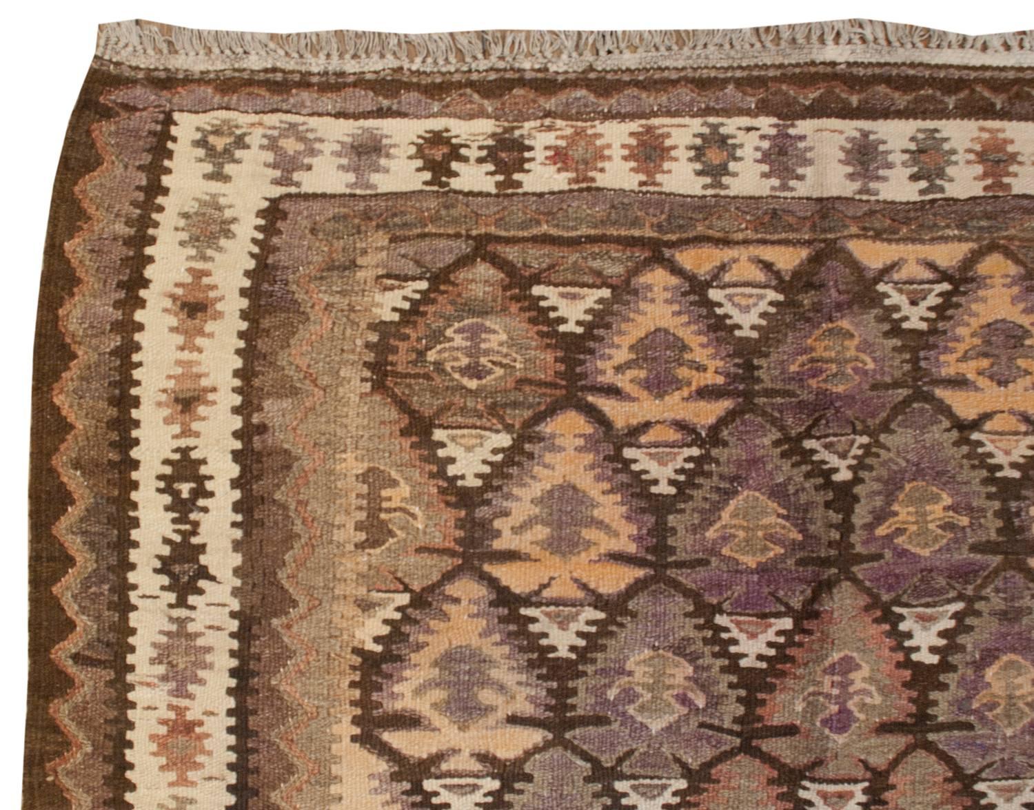 An incredible early 20th century Persian Qazvin Kilim runner with a skillfully woven tree-of-life pattern with each tree having multicolored layers. Between the trees are white triangle forms. The border is comprised of three distinct patterns. The