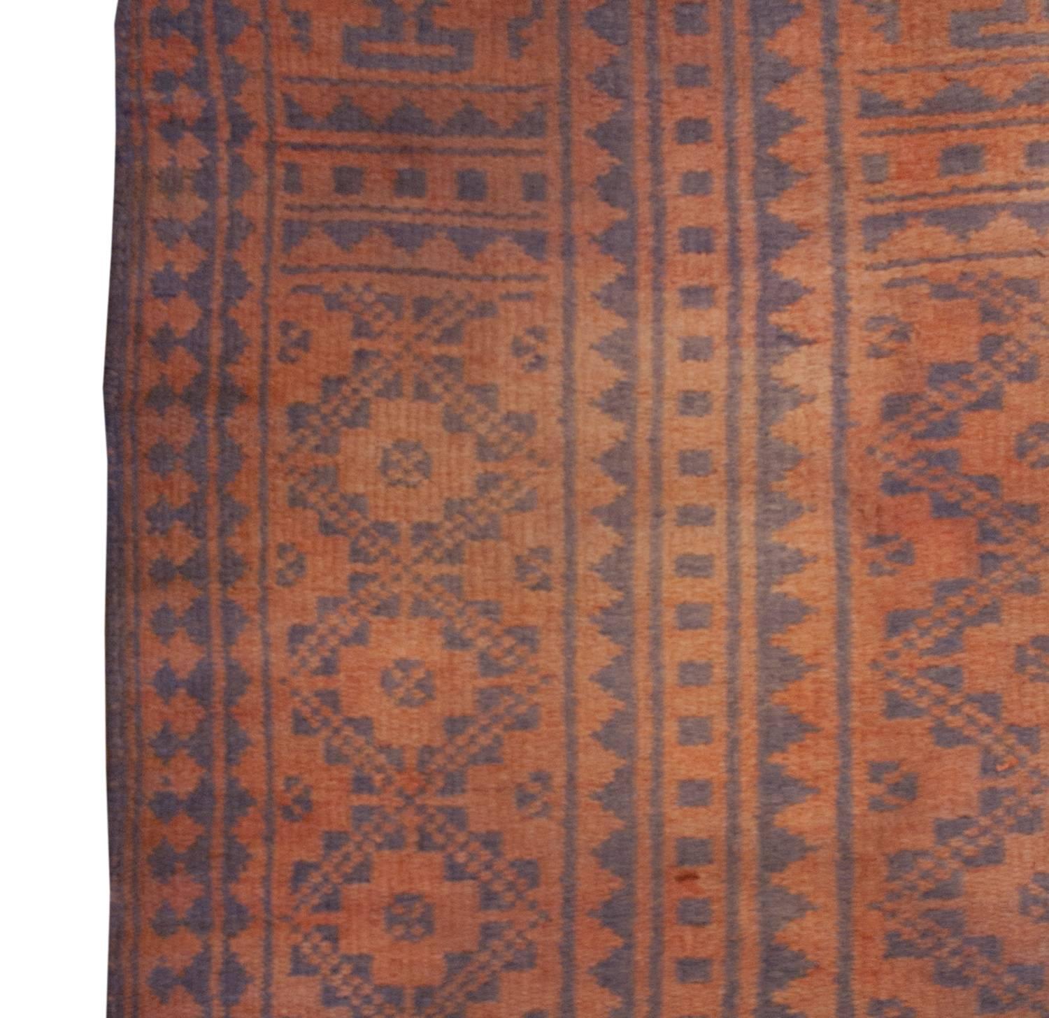 An early 20th century Persian Savek Kilim rug, woven with naturally dyed cotton, with a beautiful all-over geometric lattice-work field of red stylized diamonds on an indigo background. The border is striped, with similarly patterned lattice-work