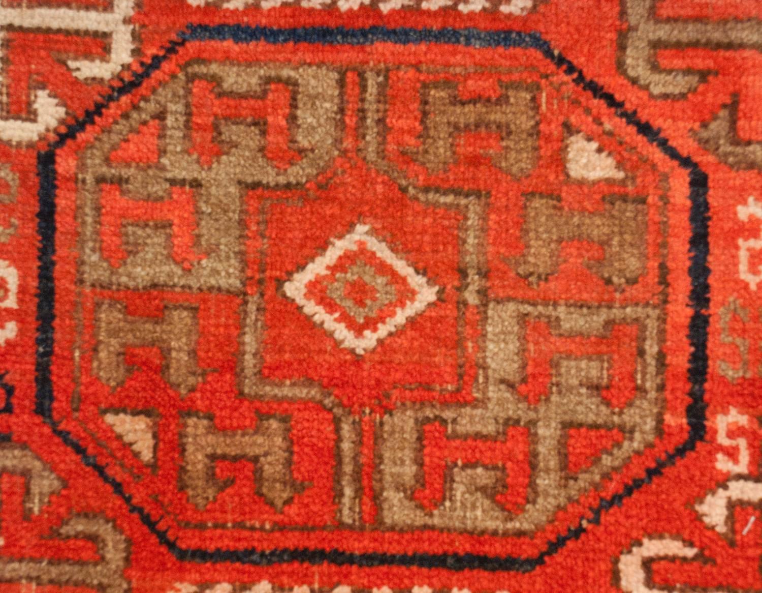 An exceptional early 20th century Persian Ersari rug with an incredible pattern with multiple octagonal medallions on a rich crimson background. Between each medallion are simple, four-armed stylized floral motifs. Each medallion contains a