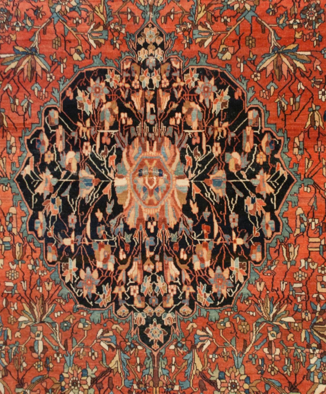 An incredible 19th century Persian Sarouk Farahan rug with a wonderful and skillfully woven pattern. The medallion is intensely woven with light indigo, crimson, orange and natural wool colors on a black background resting on an intensely woven
