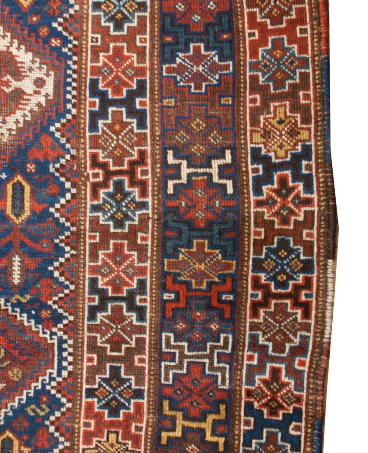 An exceptional 19th century Persian Ghashgaei rug with multiple diamonds in the field, some with intricately woven floral designs, and others with stylized figures with trees-of-life patterns. The border is fantastic, composed of three distinct
