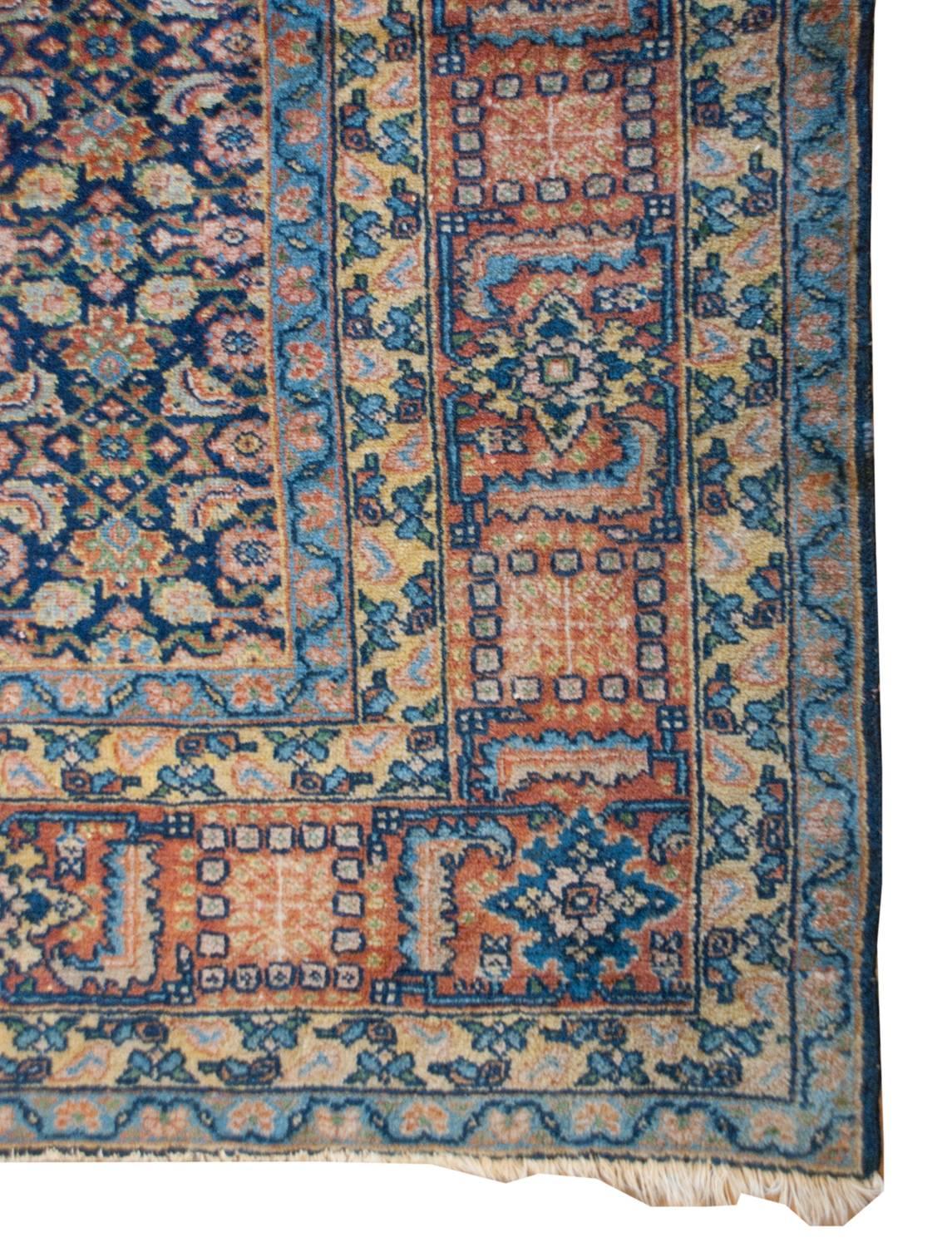 An exceptional 19th century Persian Malaya rug with an intensely woven leaf, floral and vine pattern, woven in multicolored wool on an indigo background. The border is wide, composed of five bands. The central band is fantastic with a stylized