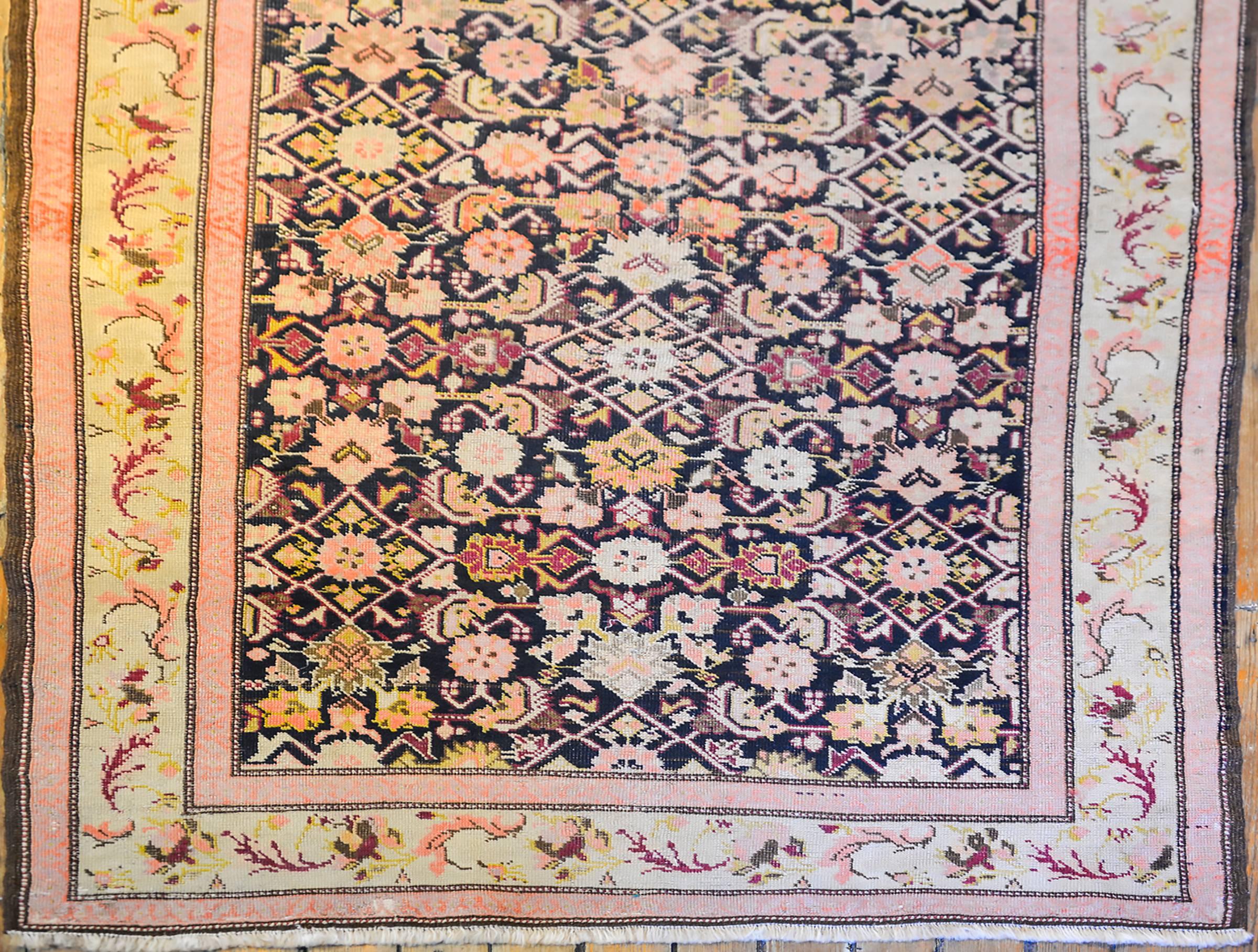A late 19th century Persian Herati runner with an all-over lattice pattern composed of pink, gold, orange and yellow flowers and leaves. The border is sweet with wonderfully rendered leaves and flowers woven in similarly vegetables wool.