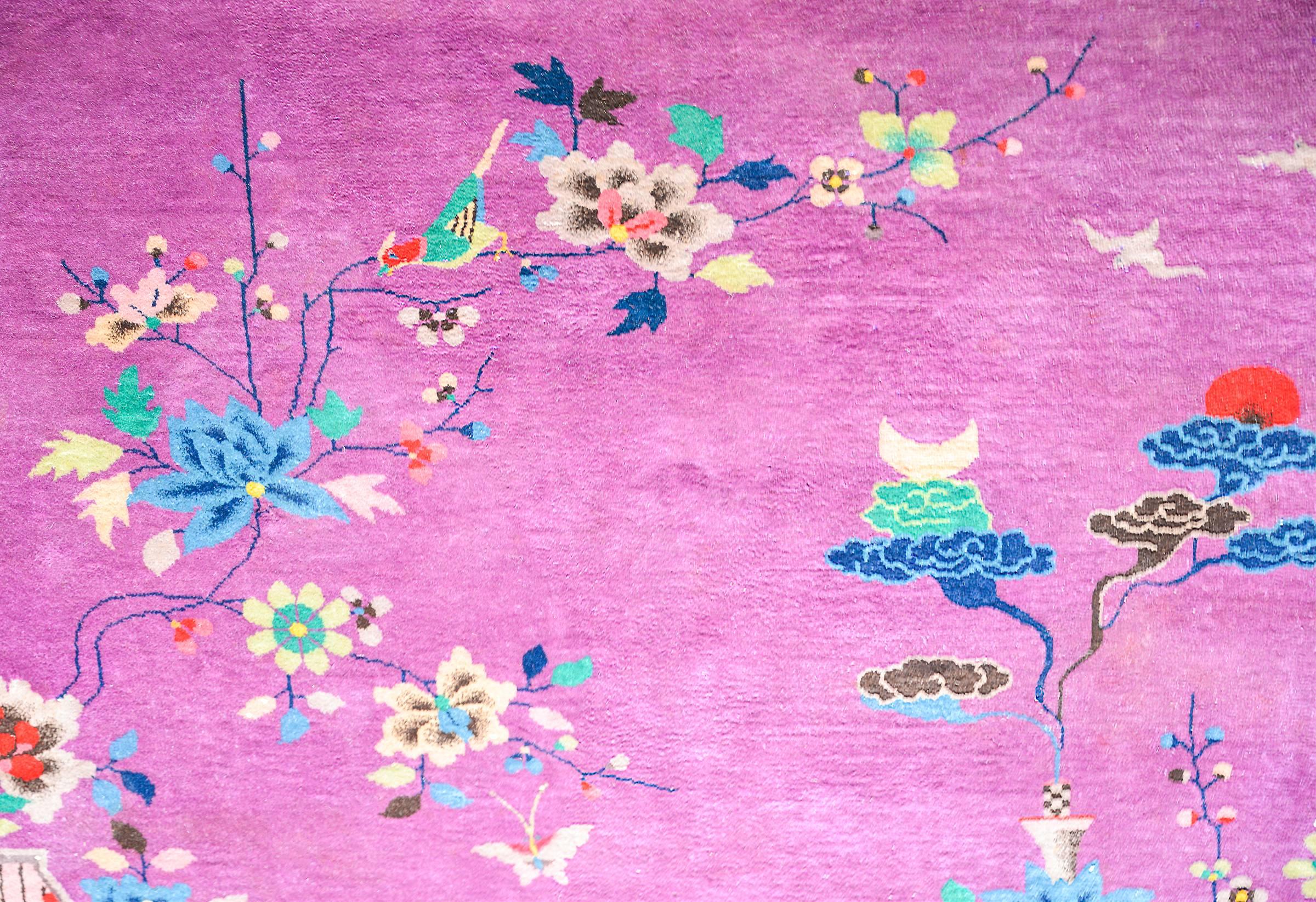 A beautiful early 20th century Chinese Art Deco rug woven with rich jewel tones including a deep amethyst purple field, surrounded by a taupe border. The central field includes an overlay of multicolored auspicious flowering chrysanthemums, peonies,