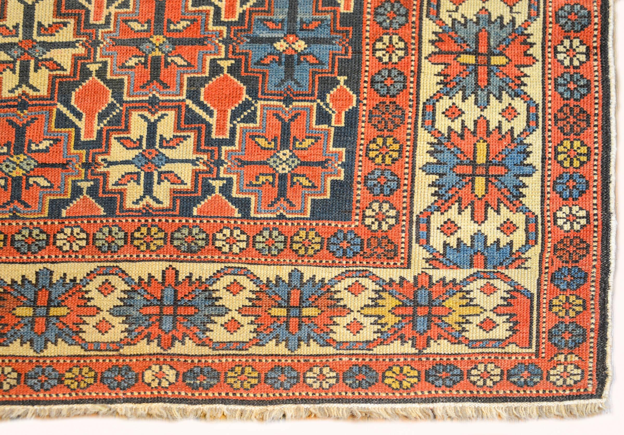 An amazing late 19th century Persian Shrivan rug with an incredible all-over geometric stylized floral pattern woven in crimson, indigo and natural wool, on a dark indigo field. The border is complementary with similar geometric floral pattern with