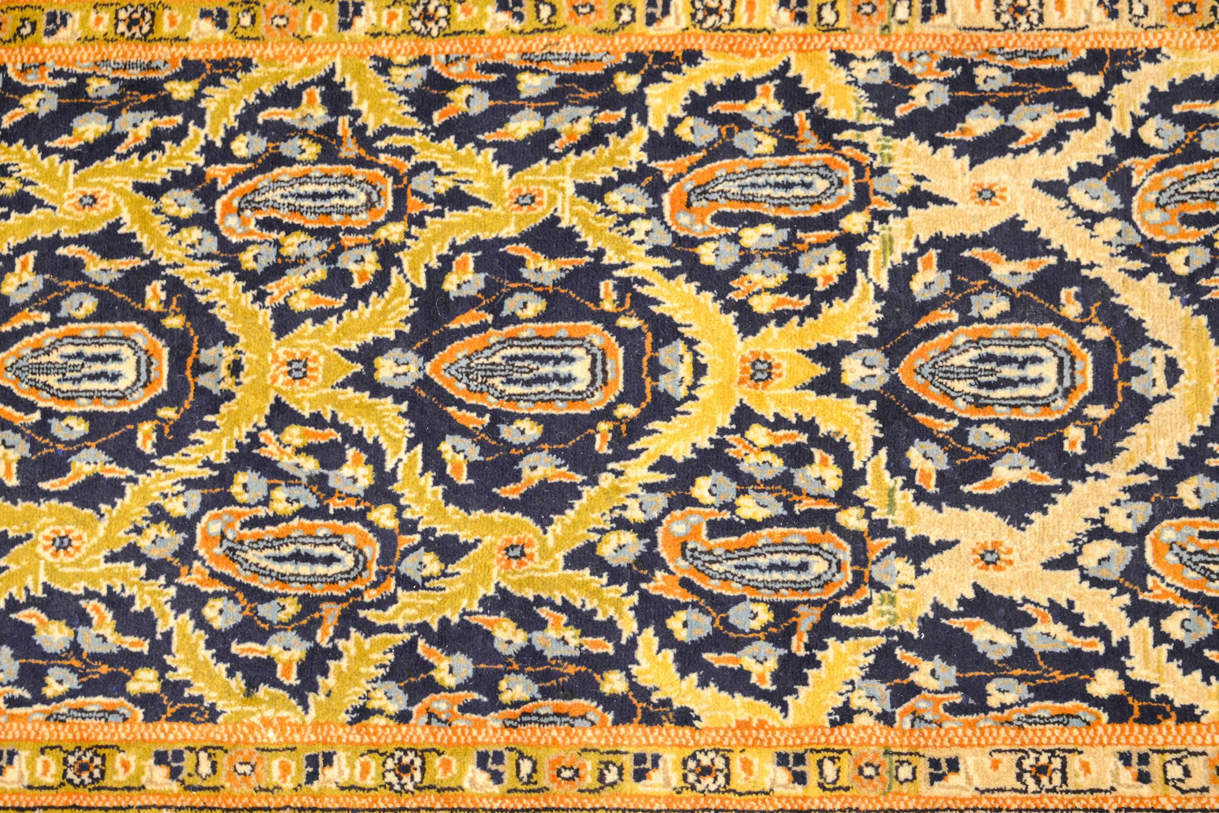 An early 20th century Persian Tabriz runner with a beautiful all-over trellis and paisley pattern woven in cream, gold, and indigo dyed wool. The border is complementary, but woven in contrasting colors of orange, white and indigo.