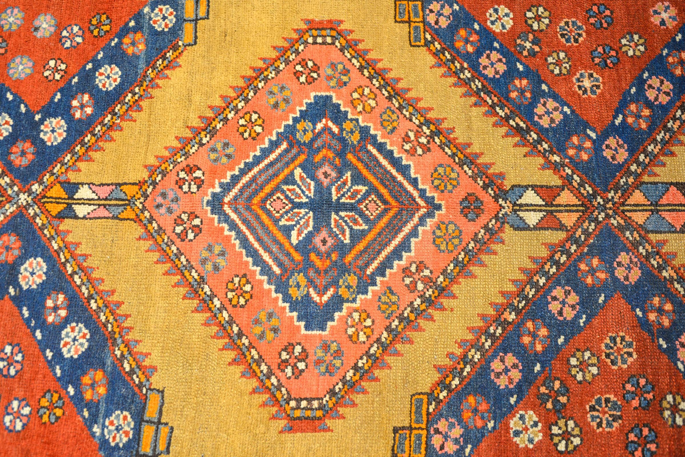 An extraordinary 19th century Persian Serab runner with a wonderful overall geometric pattern composed of several diamond medallions with multicolored flowers on a natural camel hair ground. The border is complementary in color with two diagonal