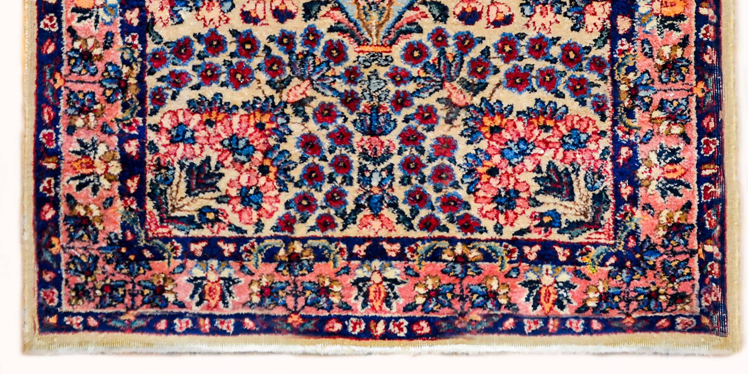 A beautiful early 20th century Persian Lavar Kirman prayer rug with a wonderful densely woven tree-of-life containing myriad variety blossoming flowers amidst a field. The border is typical, with a densely woven floral and leaf pattern, flanked by