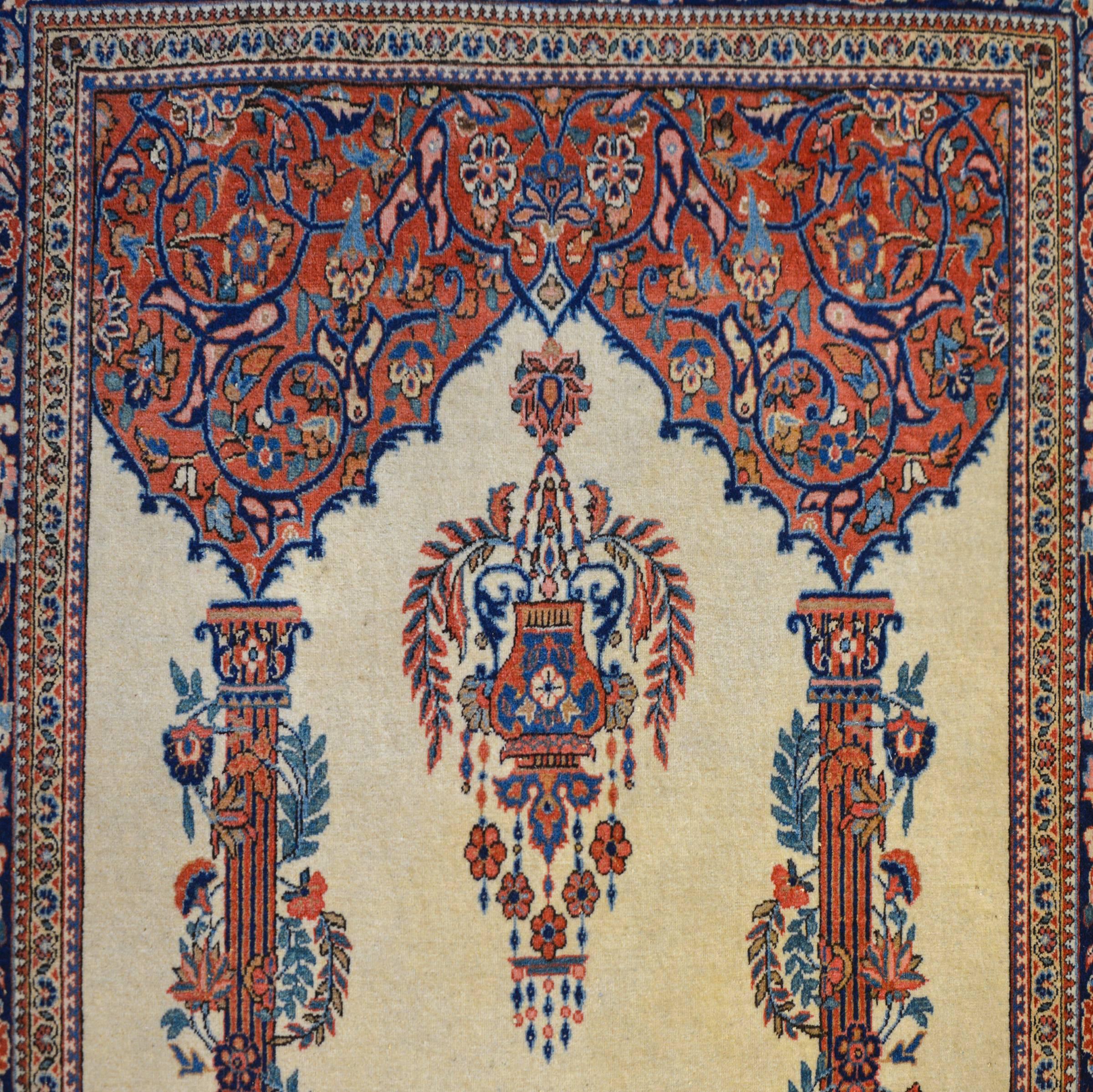 An amazing early 20th century Persian Kashan rug with an architectural design depicting two fluted columns wrapped with scrolling vines and flowers, supporting a vaulted ceiling with arabesque design. A potted planter hangs from the ceiling. The
