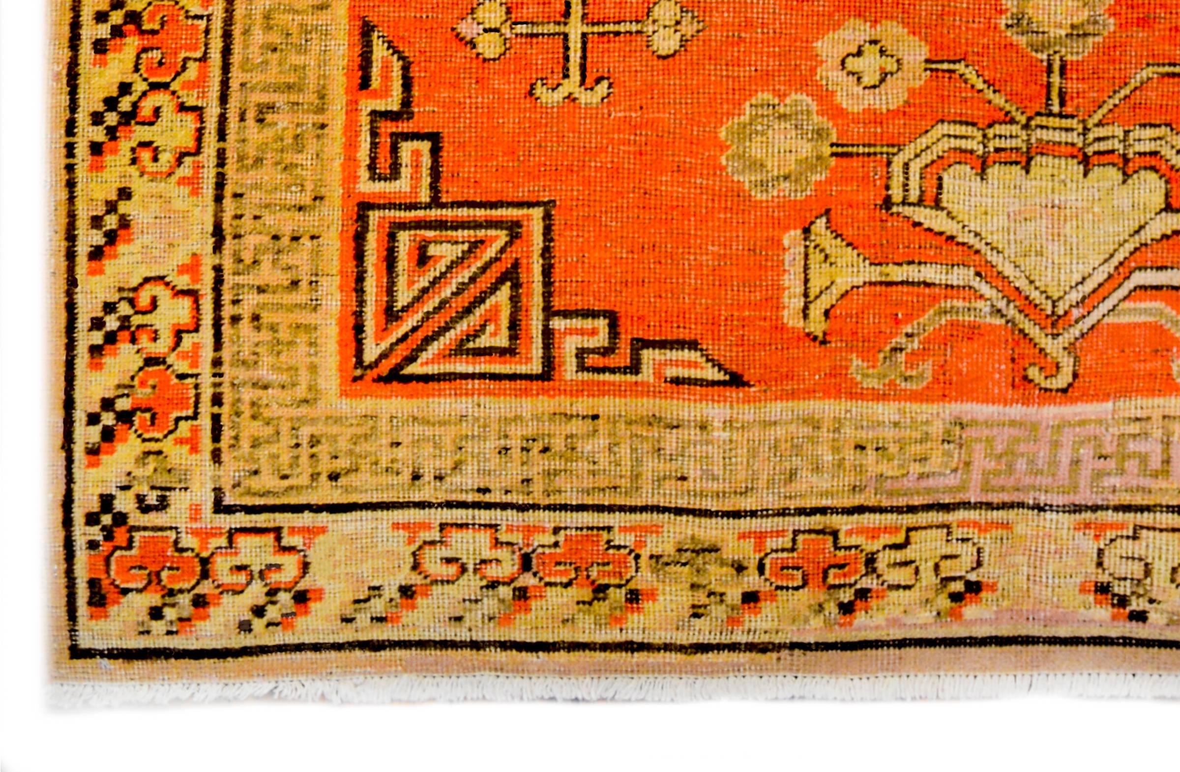 An incredible late 19th century Central Asian Samarghand rug with a wonderful stylized floral and pomegranate motif surround two large-scale medallions on a burnt orange field. The border is interesting with an abrash fade, and woven with a Chinese