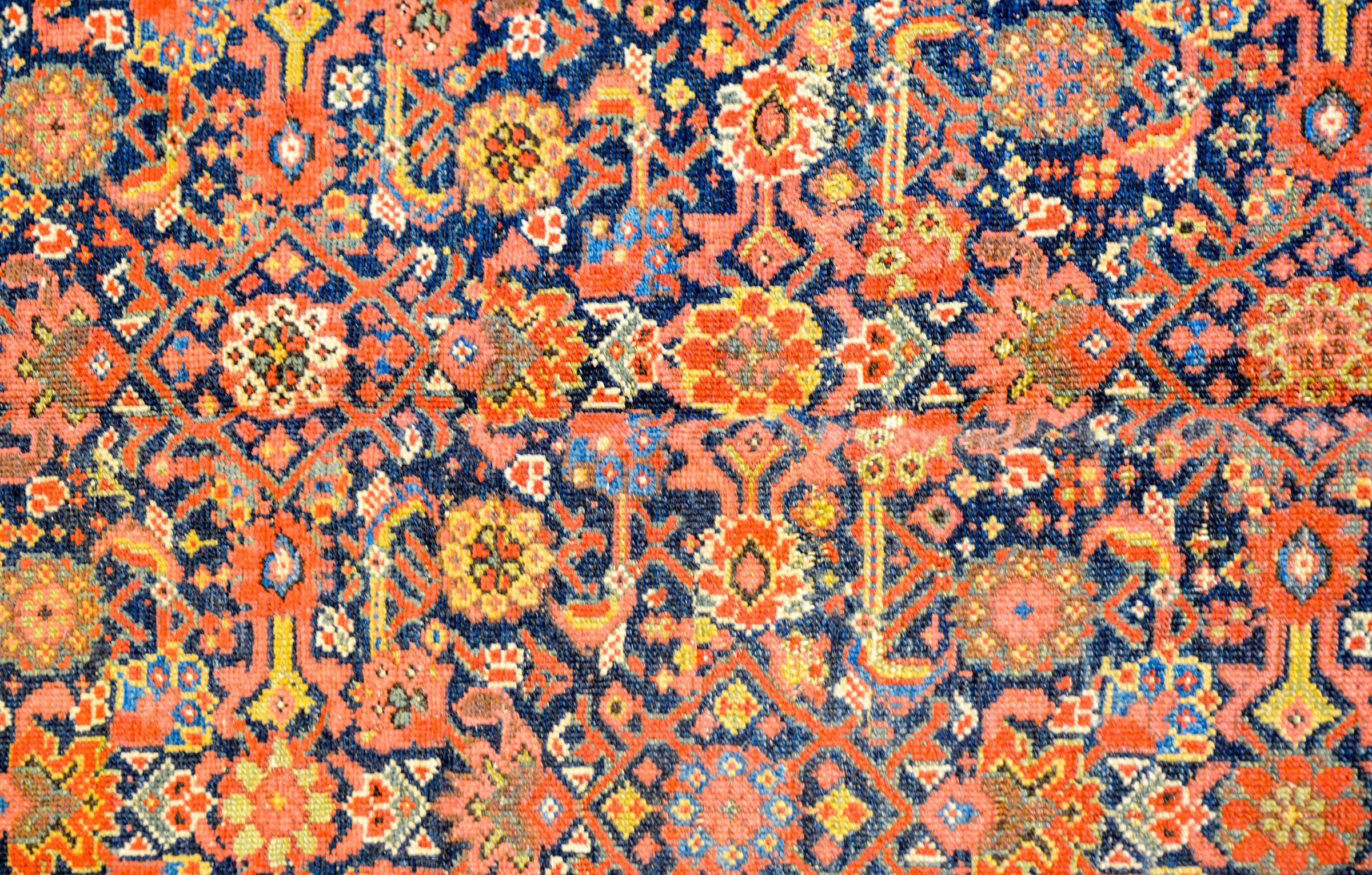 An exceptional early 20th century Persian Malayar Herati rug with an incredible pattern consisting of one of the most intensely woven all-over multicolored floral and vine trellis patterns we've ever seen, woven in crimson, indigo, gold and green,