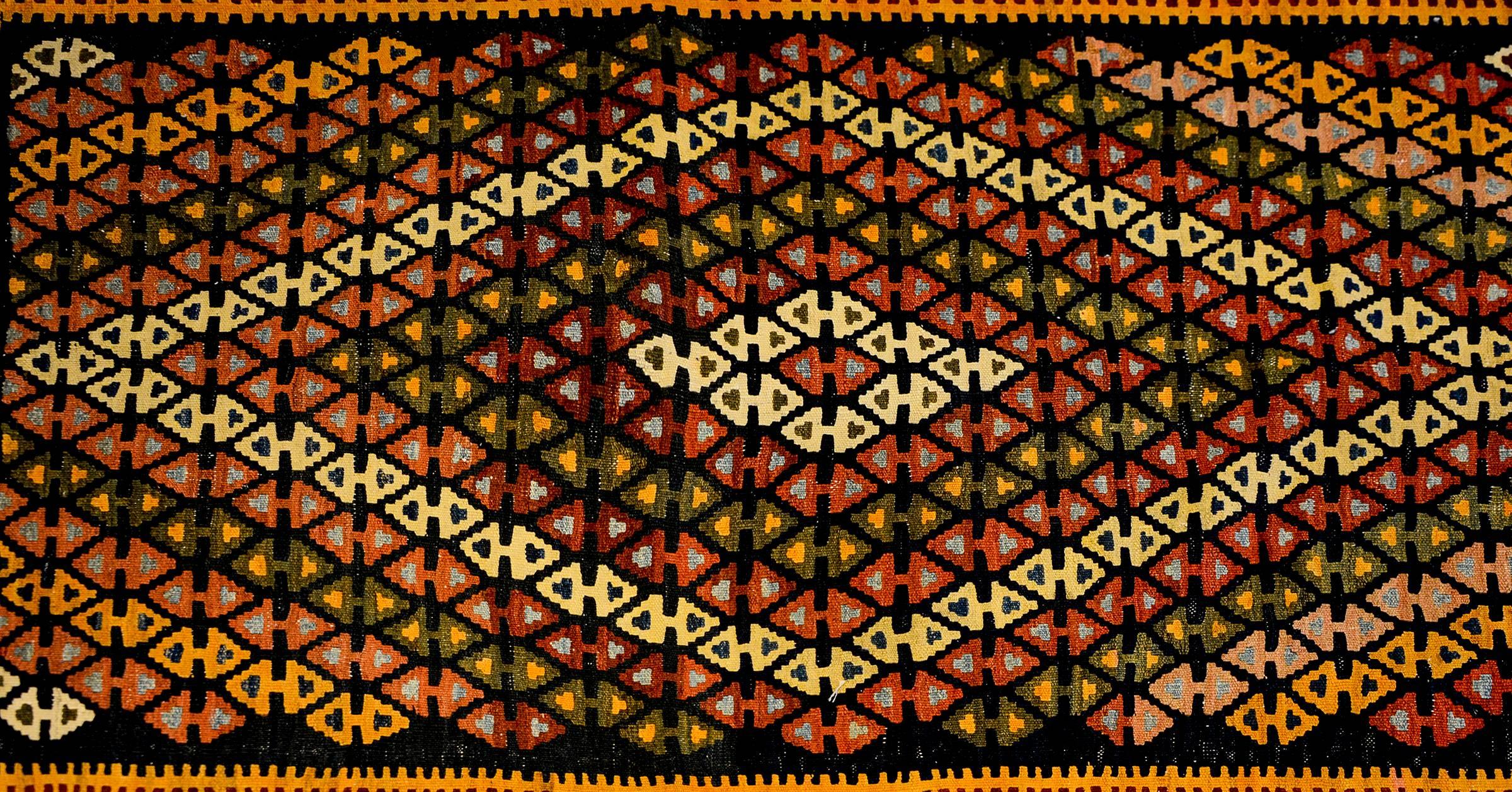 A fantastic mid-20th century Kirmanshah Runner with a wonderful all-over triangle pattern forming two diamonds in the field. The border is wide, with three distinct geometric patterns including hexagonal flower shapes, and paisleys.