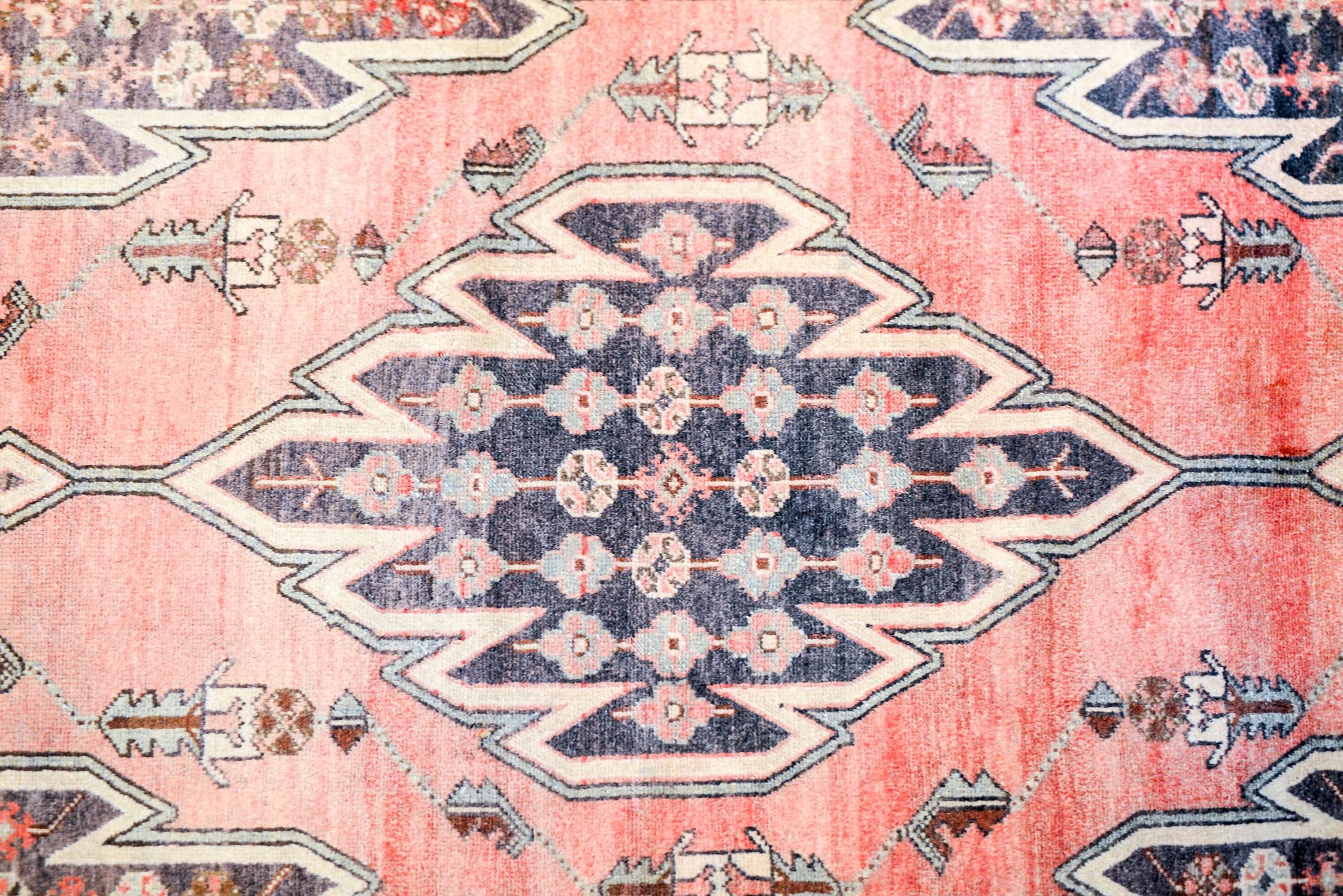 A gorgeous early 20th century Persian Malayar rug with a beautiful central diamond medallion with a an all-over floral pattern. The medallion is surrounded by a diamond field of abrash crimson with multiple leaves and stylized shrimp motifs,