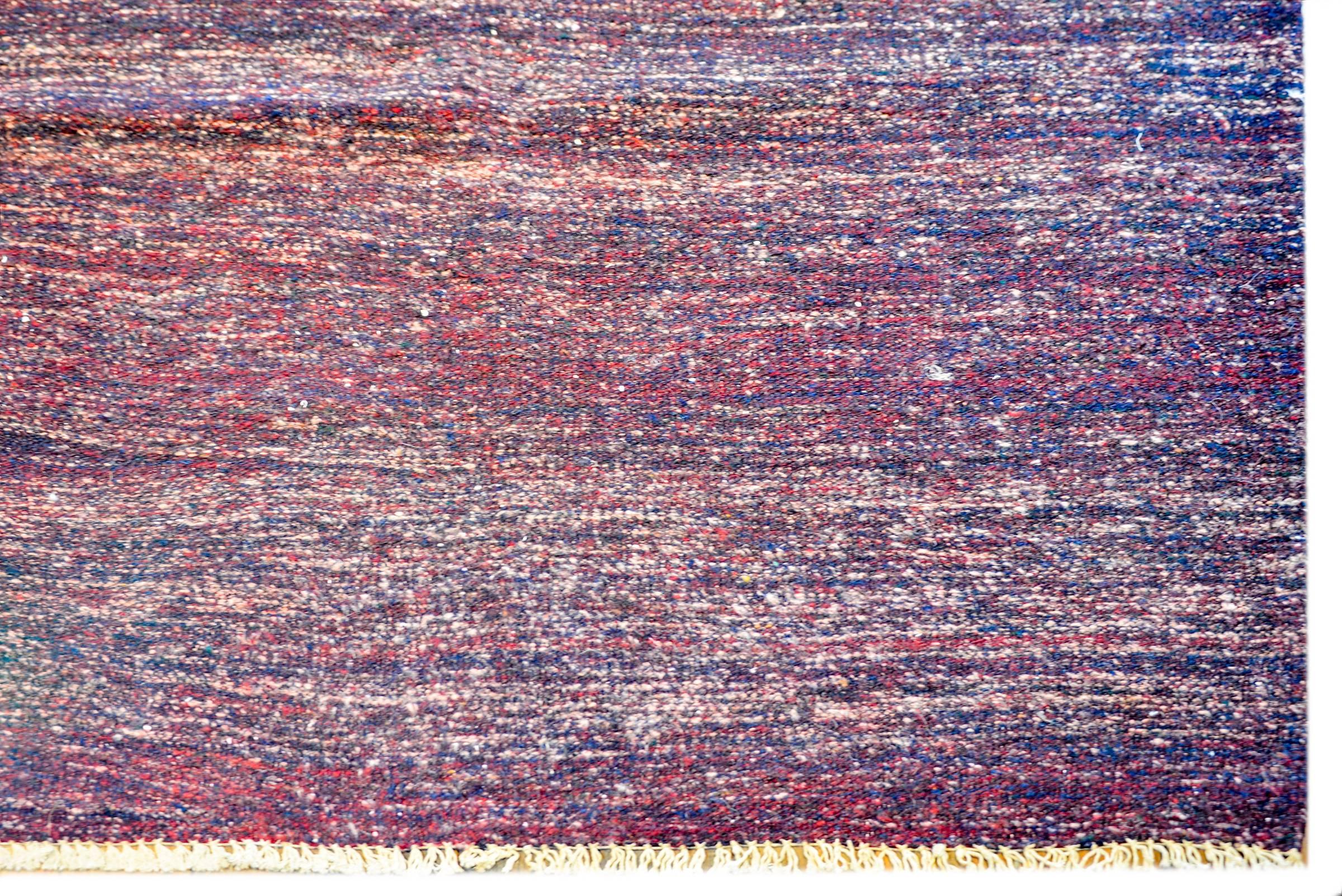 A fantastic vintage Persian Gabbeh Kilim rug woven in crimson and indigo wool with a simple whipstitched edge trim.