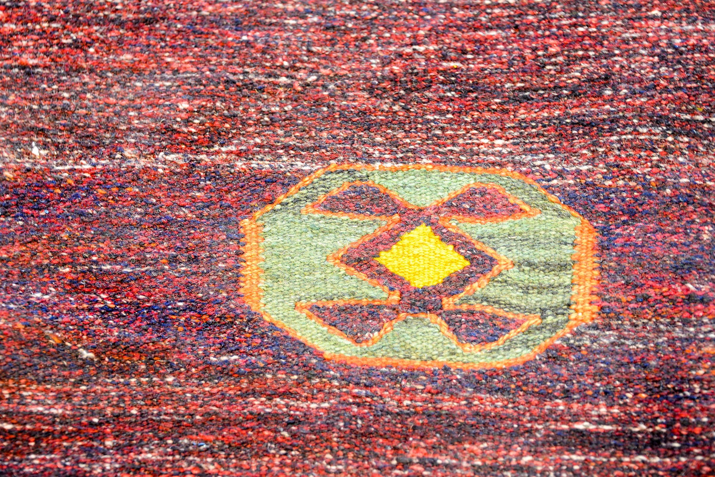 A wonderful vintage Gabbeh Kilim runner woven in beautiful red and indigo dyed wool, with one octagonal medallion floating in the field.