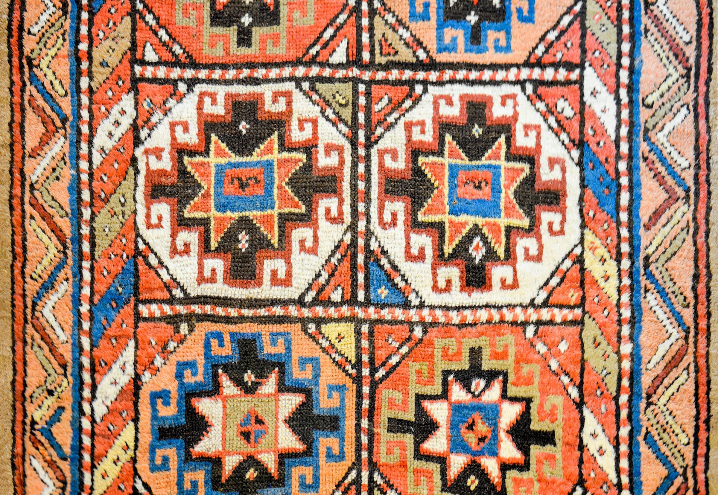 A wonderful early 20th century Persian Moghan runner with multiple multicolored diamond medallions on a camel hair background. The border is simple, with a diagonal stripe pattern woven in multicolored wool, with a wide camel hair outer-stripe.