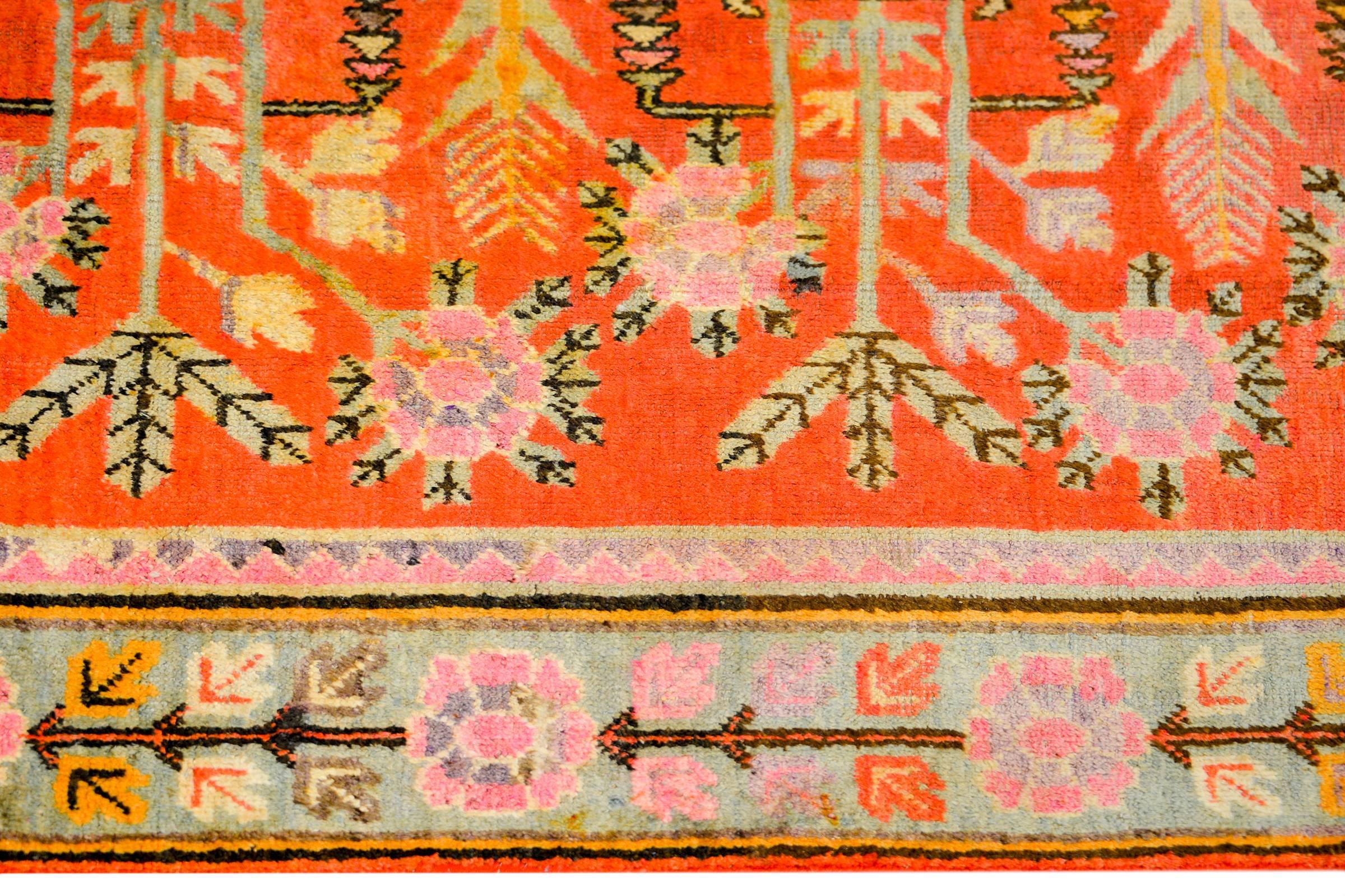A wonderful early 20th century Central Asian pictorial Khotan rug with six large-scale Chinese-style vases potted with auspicious peony blossoms, and woven in multicolored vegetable dyed wool. The border is fantastic with a stylized large-scale