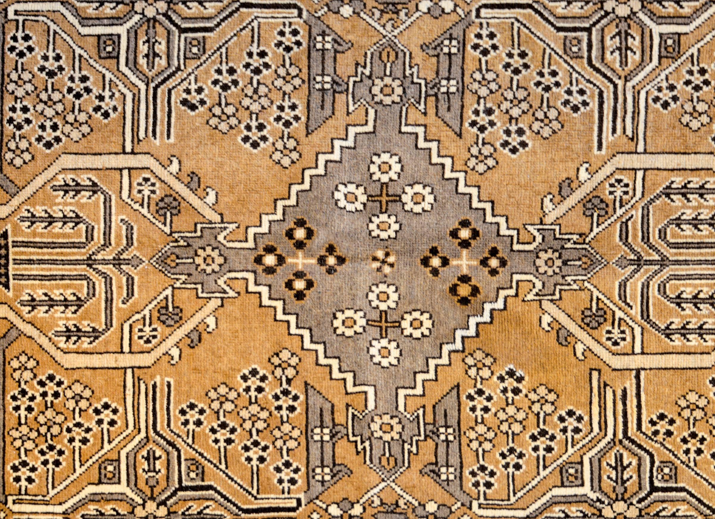 A wonderful early 20th century Persian Bakhtiari rug with a wonderful all-natural, undyed, wool color palette. The central field is mirrored, depicting multiple geometric patterns within diamond shapes, and a couple willow trees with other flowers