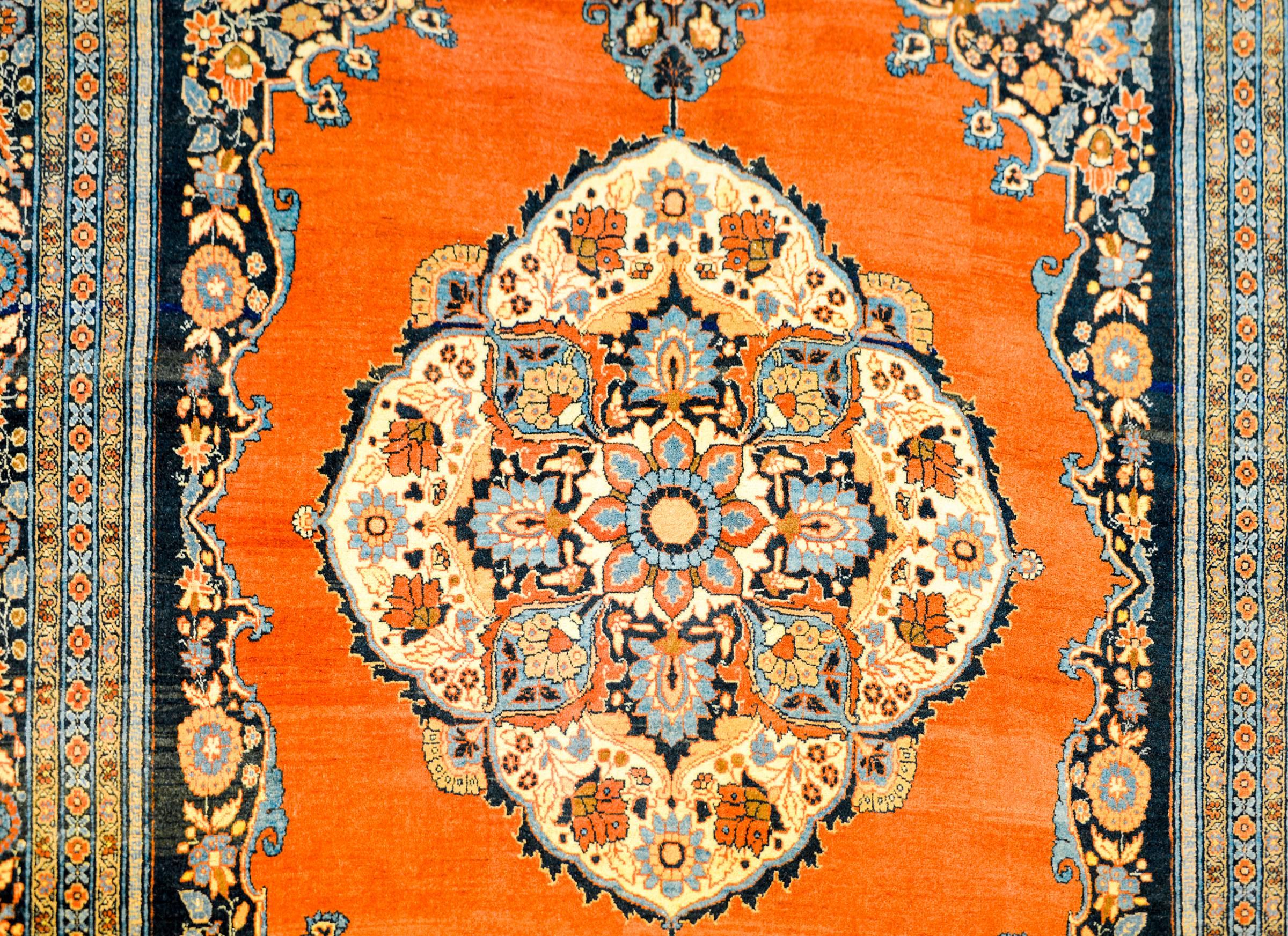 A wonderful vintage, Persian Tabriz rug with a mesmerizing pattern of intricately and tightly woven pattern of multicolored flowers on a bold orange background. The border is complex with a large central paisley patterned field with scrolling vines