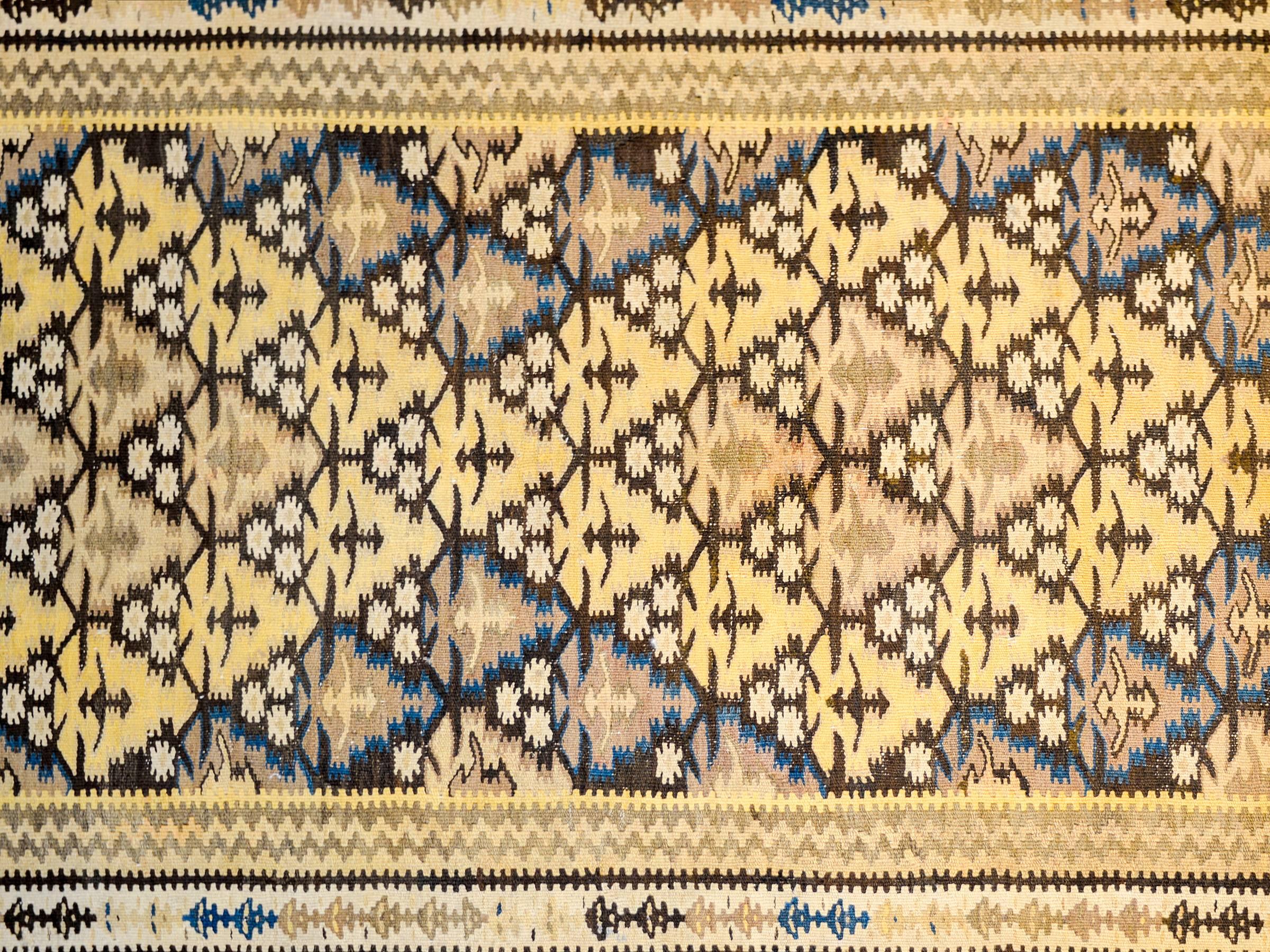 An amazing mid-20th century Persian Qazvin Kilim runner with an all-over tree-of-life pattern woven in a way that creates a diamond pattern of gold, indigo, and natural wool colored trees. The border is complex, with three distinct floral and