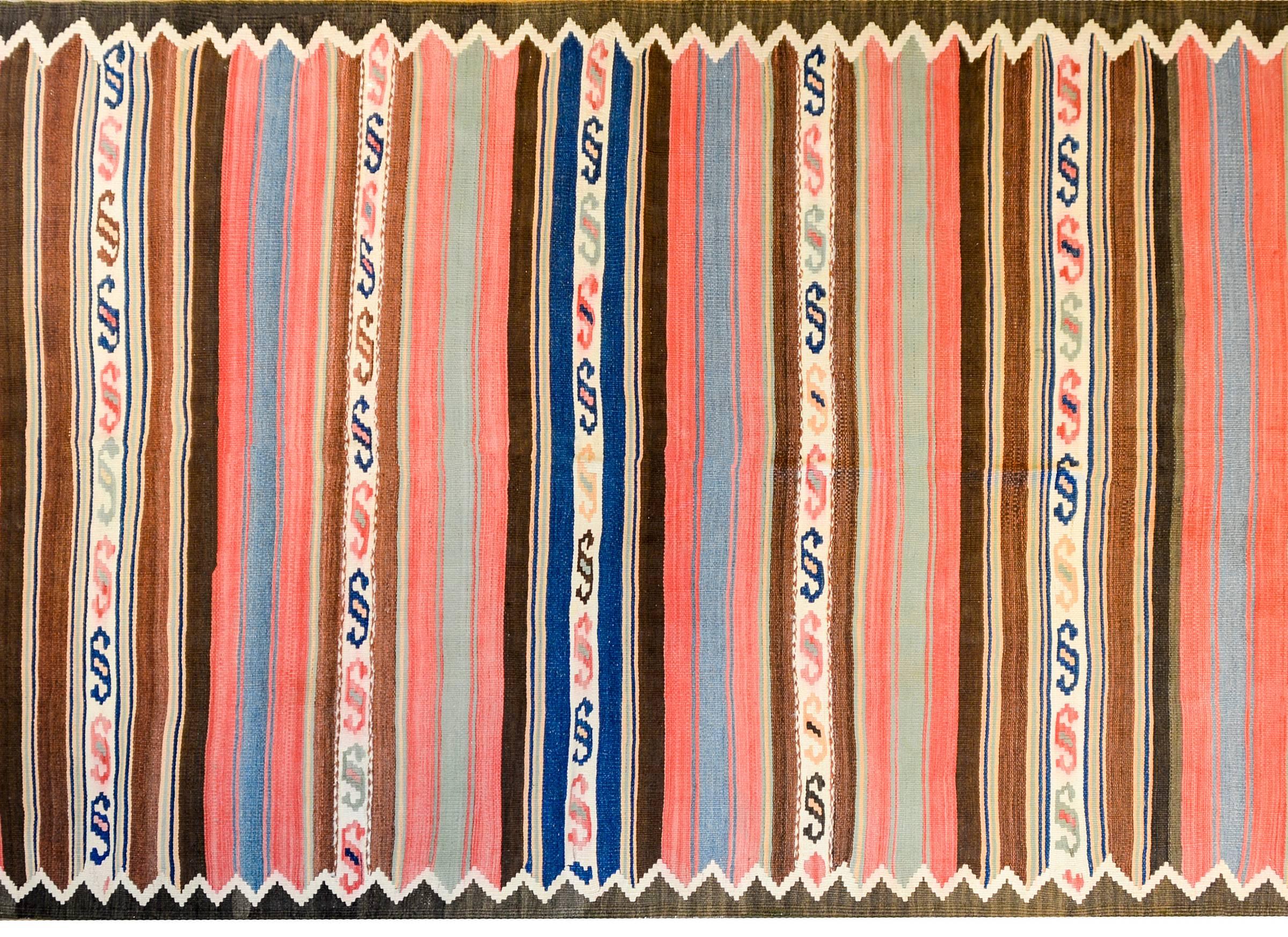 A wonderful early 20th century Persian Shahsevan Kilim runner with alternating boldly colored multicolored stripes of geometric and striped design. The border is thin, with a triangle and zigzag pattern.