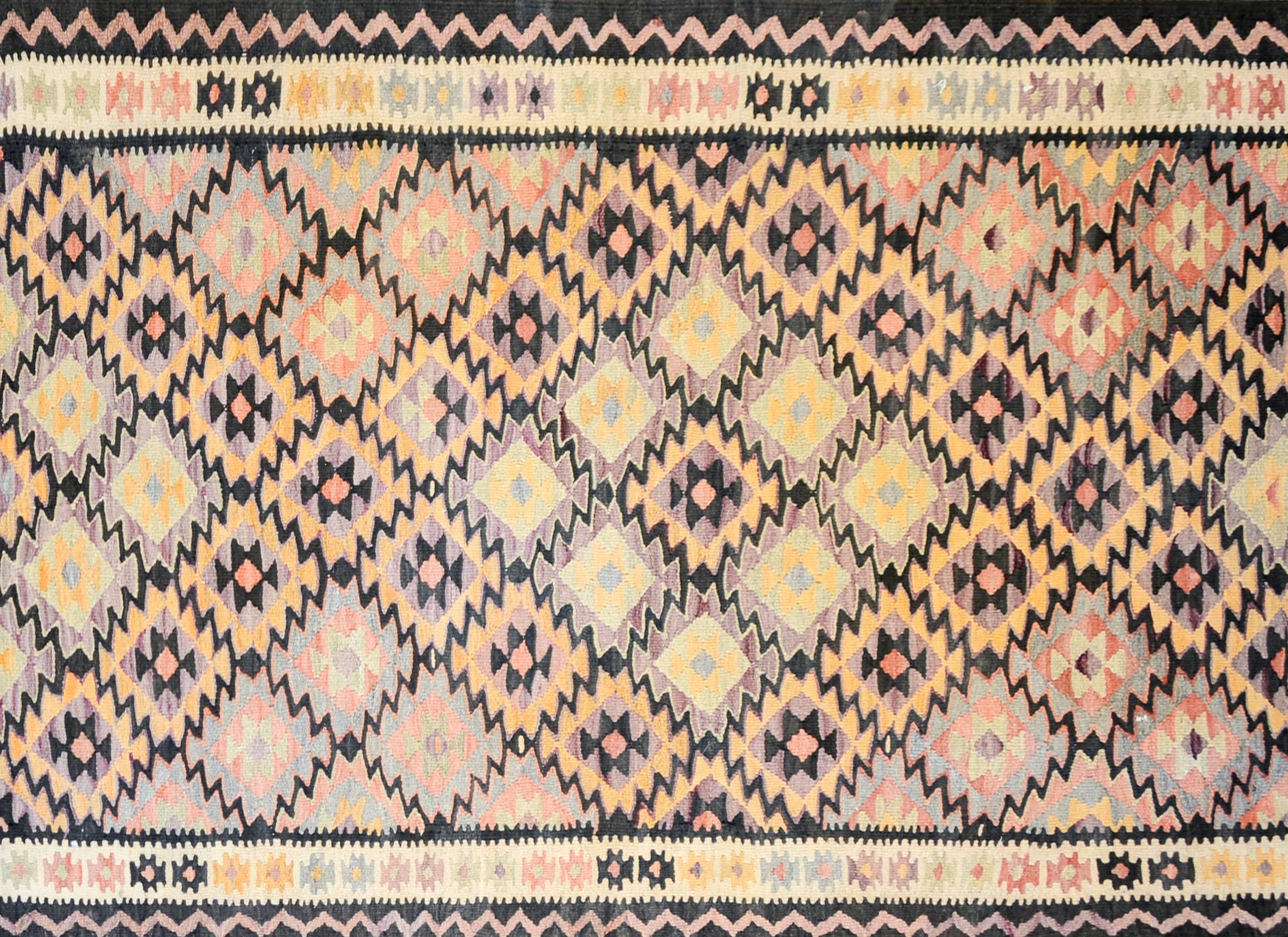 An amazing mid-20th century Persian Qazvin Kilim runner with an multi-colored diamond pattern woven in such a way that a larger diamond pattern of orange, lilac, black and natural wool colored diamonds is created. The border is complex, with two