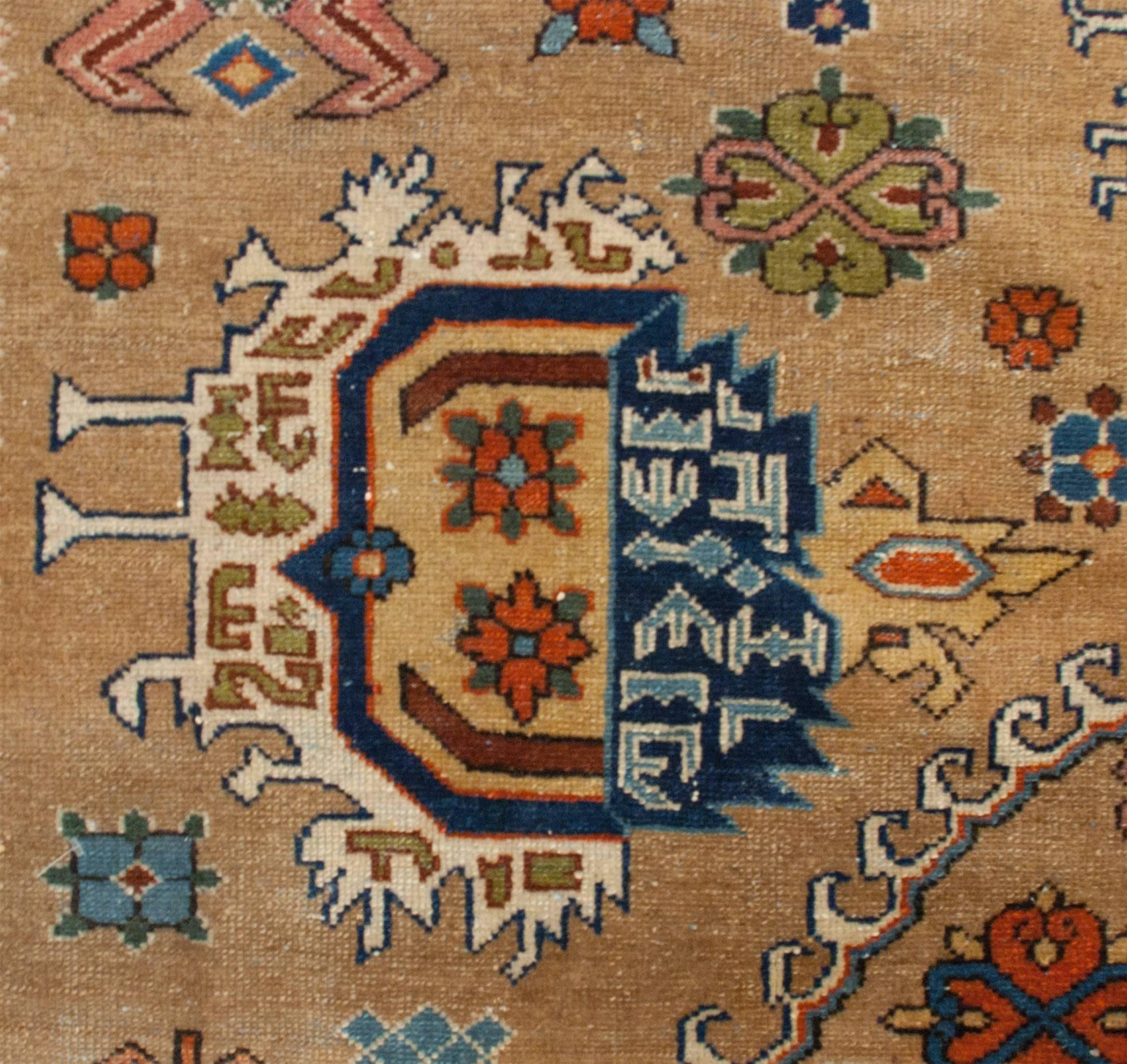 An unbelievable 19th century camel hair Persian Malayer woven with an amazing large multicolored medallion with large-scale pink geometric motifs amidst a field of flowers natural undyed camel hair background, surrounded by a complimentary geometric
