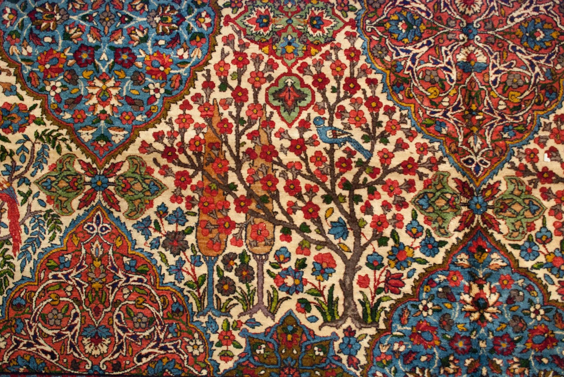 An unbelievable late 19th century Yazd rug with the most amazing intricately woven multicolored pattern of diamond shapes, each woven with unique myriad varieties of flowering vines, trees, and shrubs, with birds perched on branches. The border is