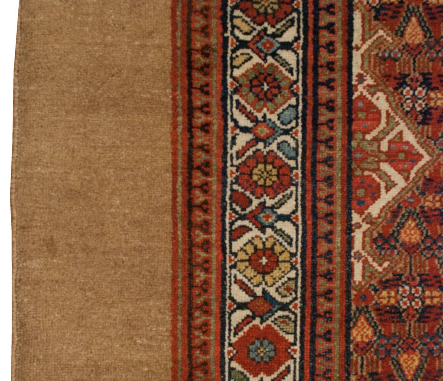 A late 19th century Persian Serab runner with a wonderfully sophisticated multicolored geometric and floral field with three large diamond medallions with a beautiful crimson, light indigo and green floral pattern. The border is wonderful, with a