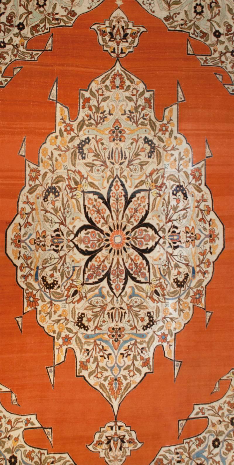 A truly masterful mid-19th century Persian Haji Jalili Tabriz rug with a unique color palette. The central medallion is skillfully rendered, almost cartoon like, with scrolling vines with myriad multicolored flowers. The medallion rests on an