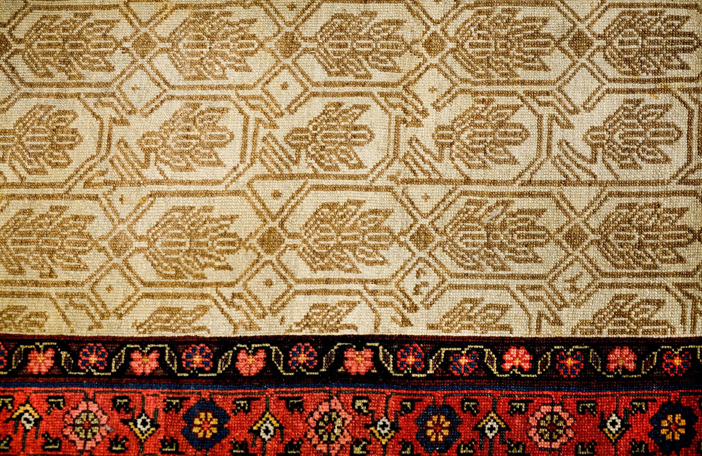 An exceptional Persian Serab runner circa 1900 with an incredible field depicting a beautiful trellis pattern with large-scale leaves woven in a fantastic natural undyed cream and beige wool. The border is wonderful with multicolored flowers and
