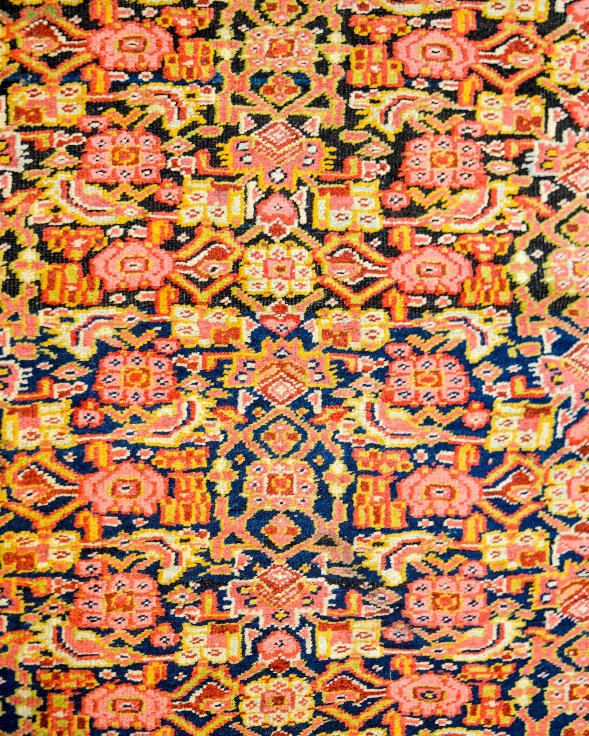 A wonderful early 20th century Persian Bidjar rug with an all-over lattice floral pattern woven in crimson, pink, gold, and indigo, on a beautiful indigo background. The border is amazing, composed of multiple floral patterned stripes.