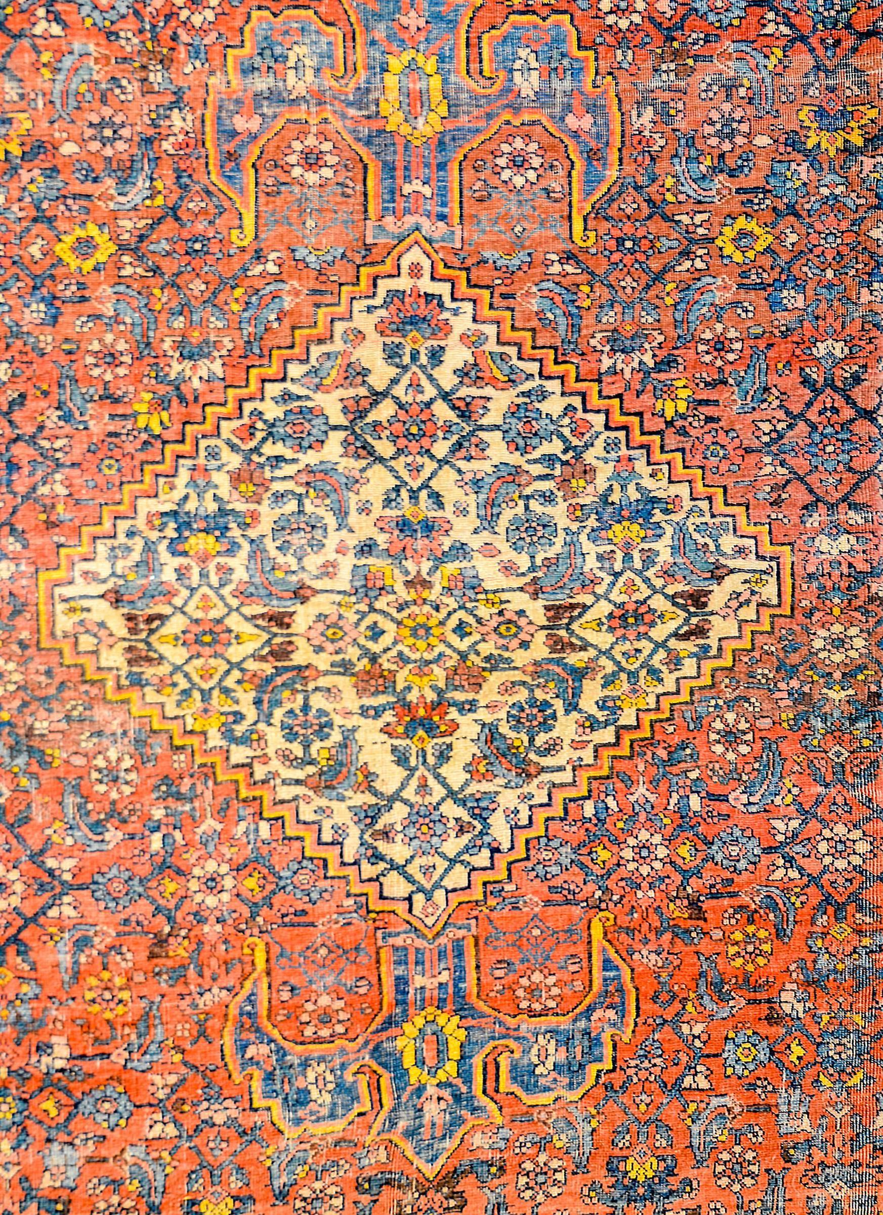 An amazing late 19th century Persian Bidjar rug with intricately woven floral pattern with a central diamond medallion woven in light and dark indigo, crimson, and gold colored wool on a crimson background. The border in composed with multiple