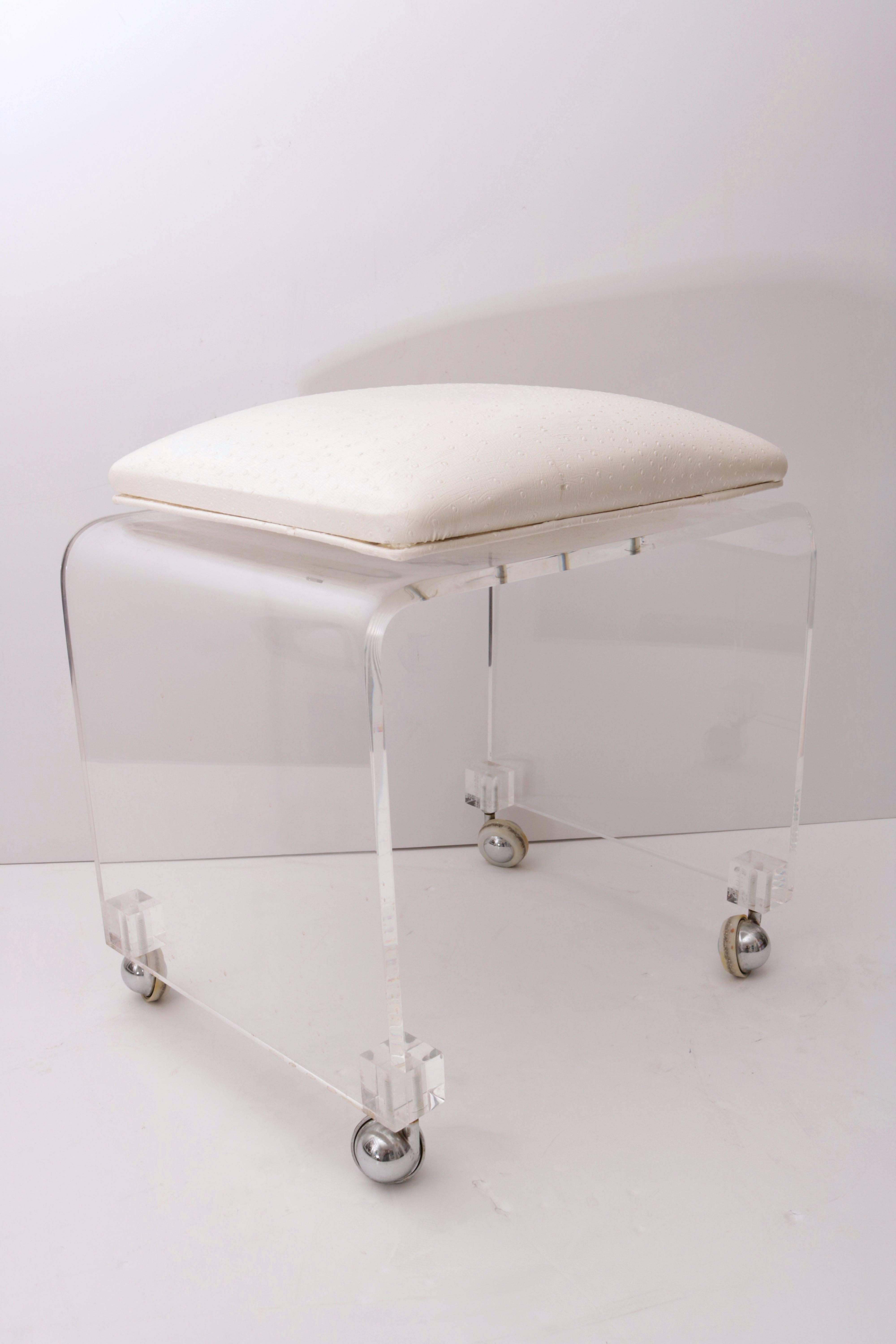 This piece will make the perfect perch for your vanity table or perhaps the dressing room. The waterfall-form is clean and smooth and will mix with all design styles. The vinyl seat is a vinyl ostrich-pattern fabric in ivory-cream and swivels for