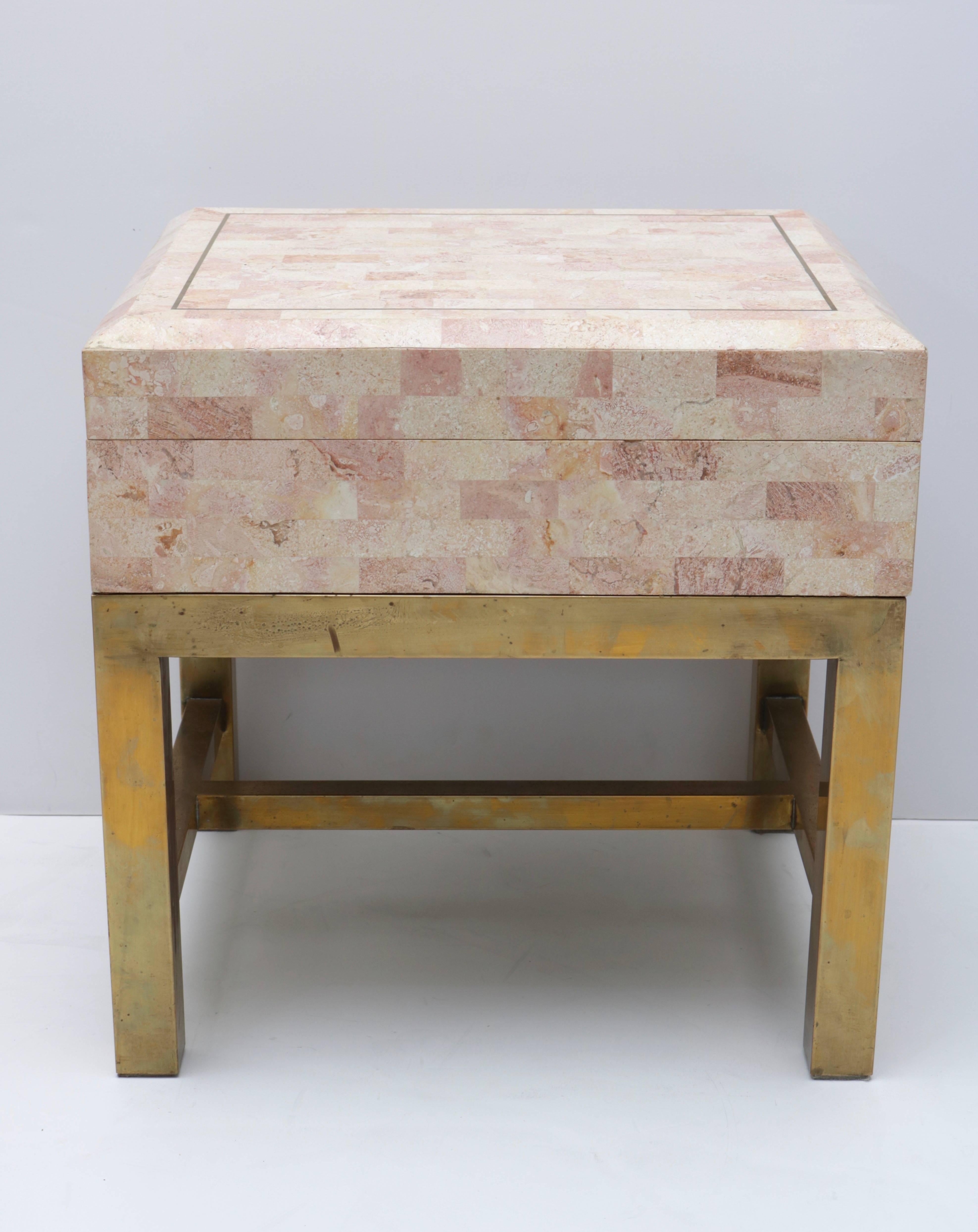 This stylish piece is very much in the manner of pieces created by Maitland Smith in the 1980s and 1990s with its tessellated marble veneers and antique brass metal accents and stand.

Note: Colors are a soft rosey-beige-cream.

For best net