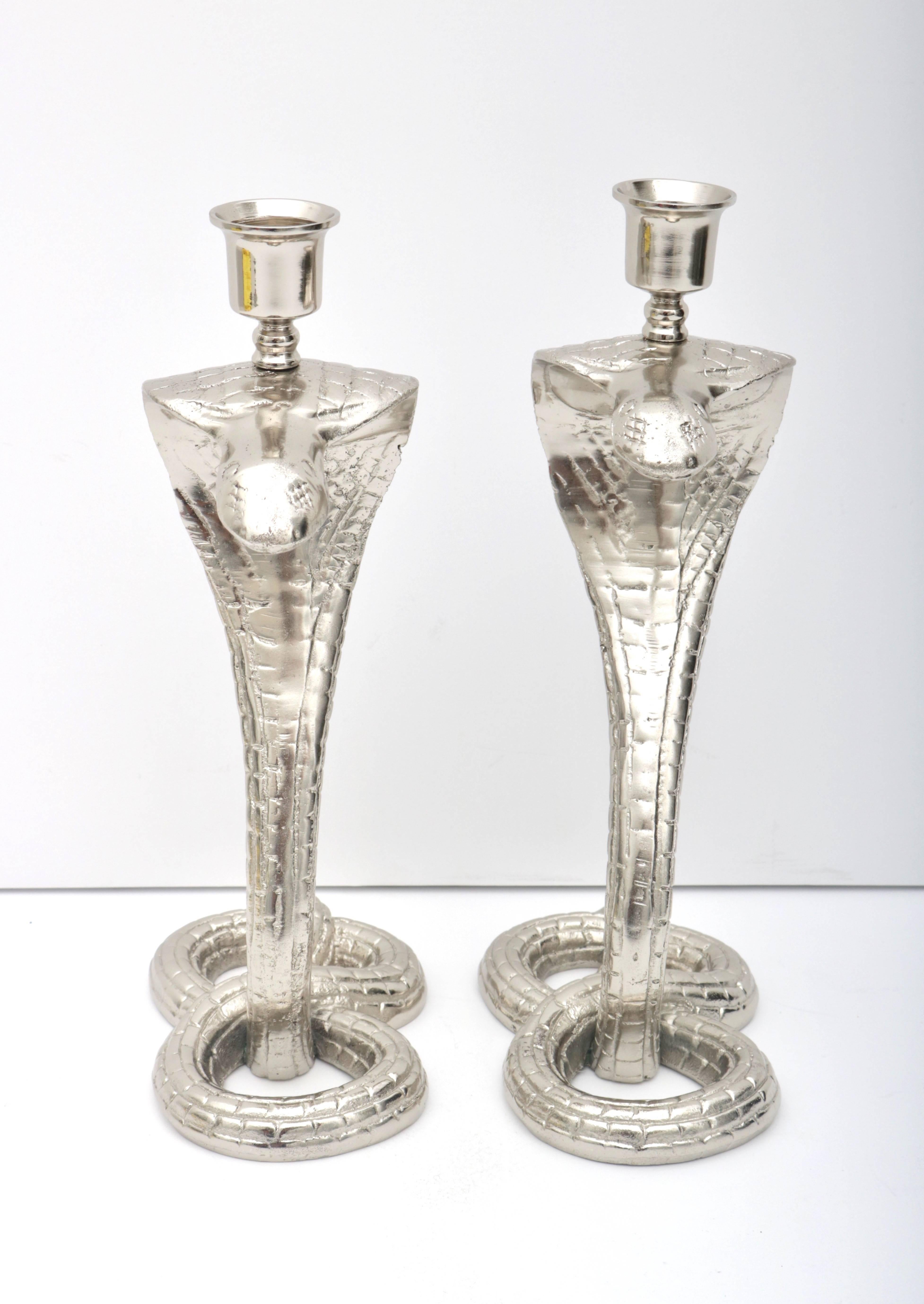 This stylish and exotic pair of cobra-form candle sticks date from the 1920s during the height of the Tutankhamun discoveries in Egypt. They are fabricated in solid bronze and have recently been professionally nickel-plated and lacquered.

