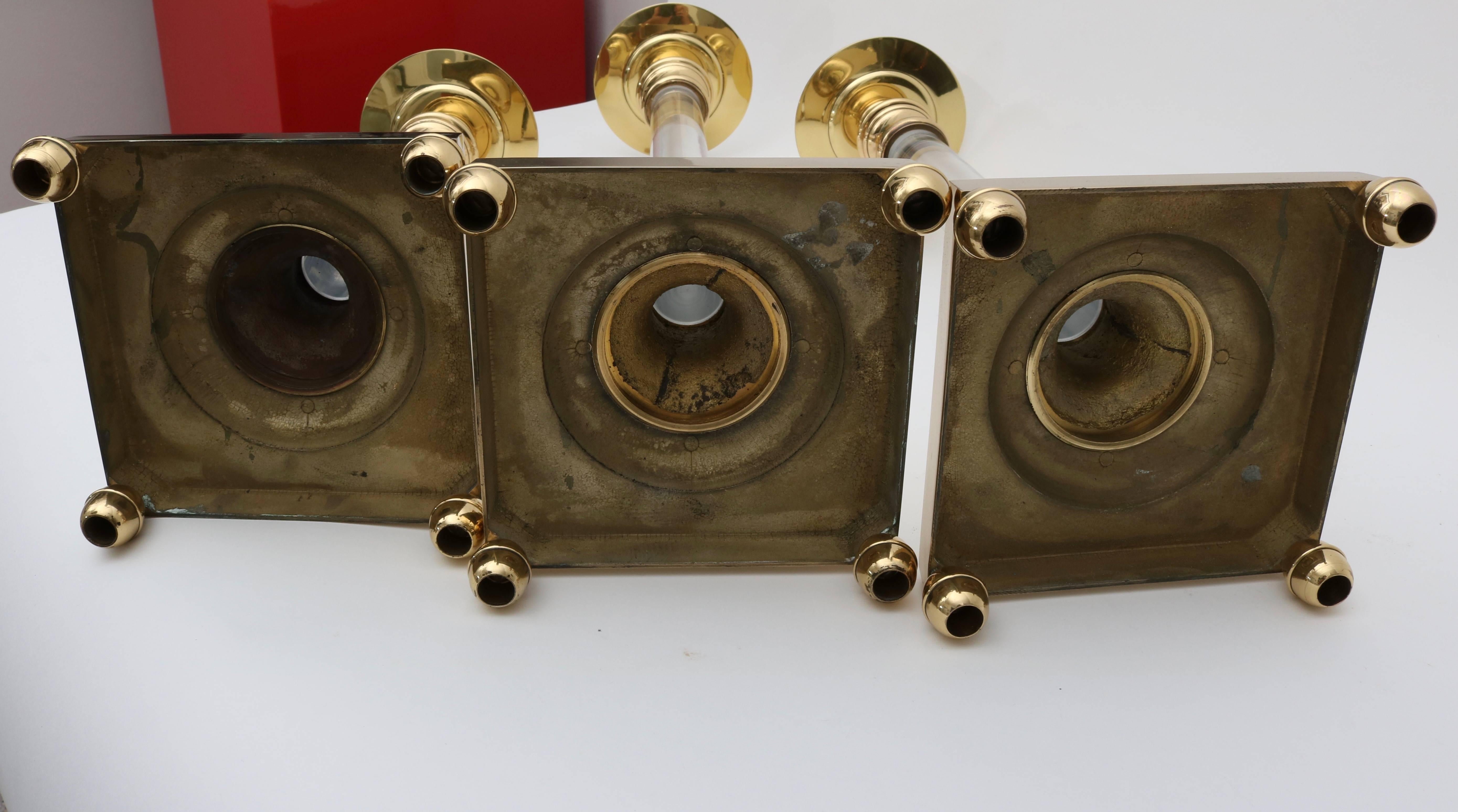 Lacquered Set of Three Polished Brass and Lucite Candlesticks For Sale