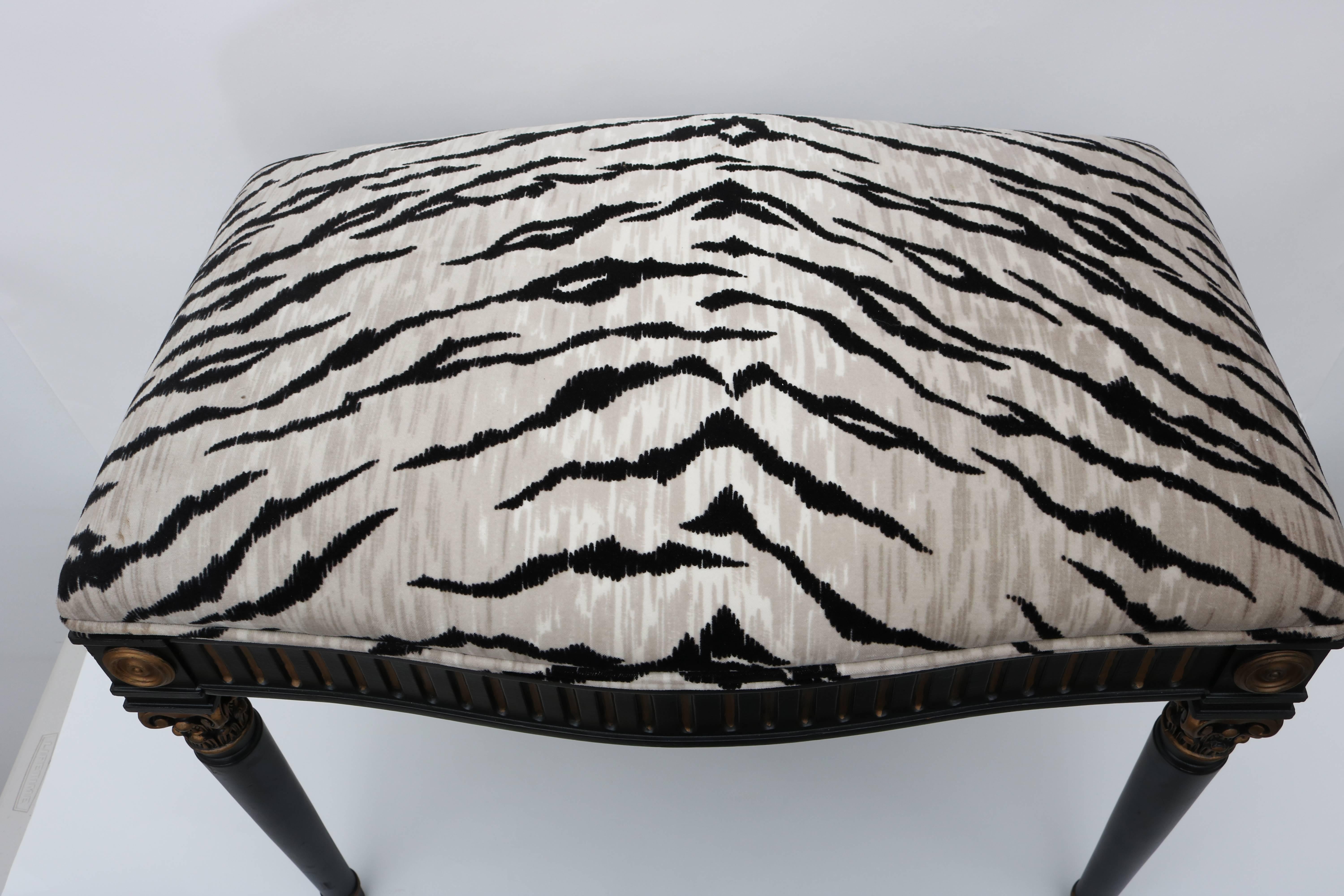 This stylish Louis XVI style bench was recently acquired for a Palm Beach estate. The piece is upholstered in a woven Bengal tiger pattern in silver and black which compliments the black and gold frame.

For best net trade price or additional