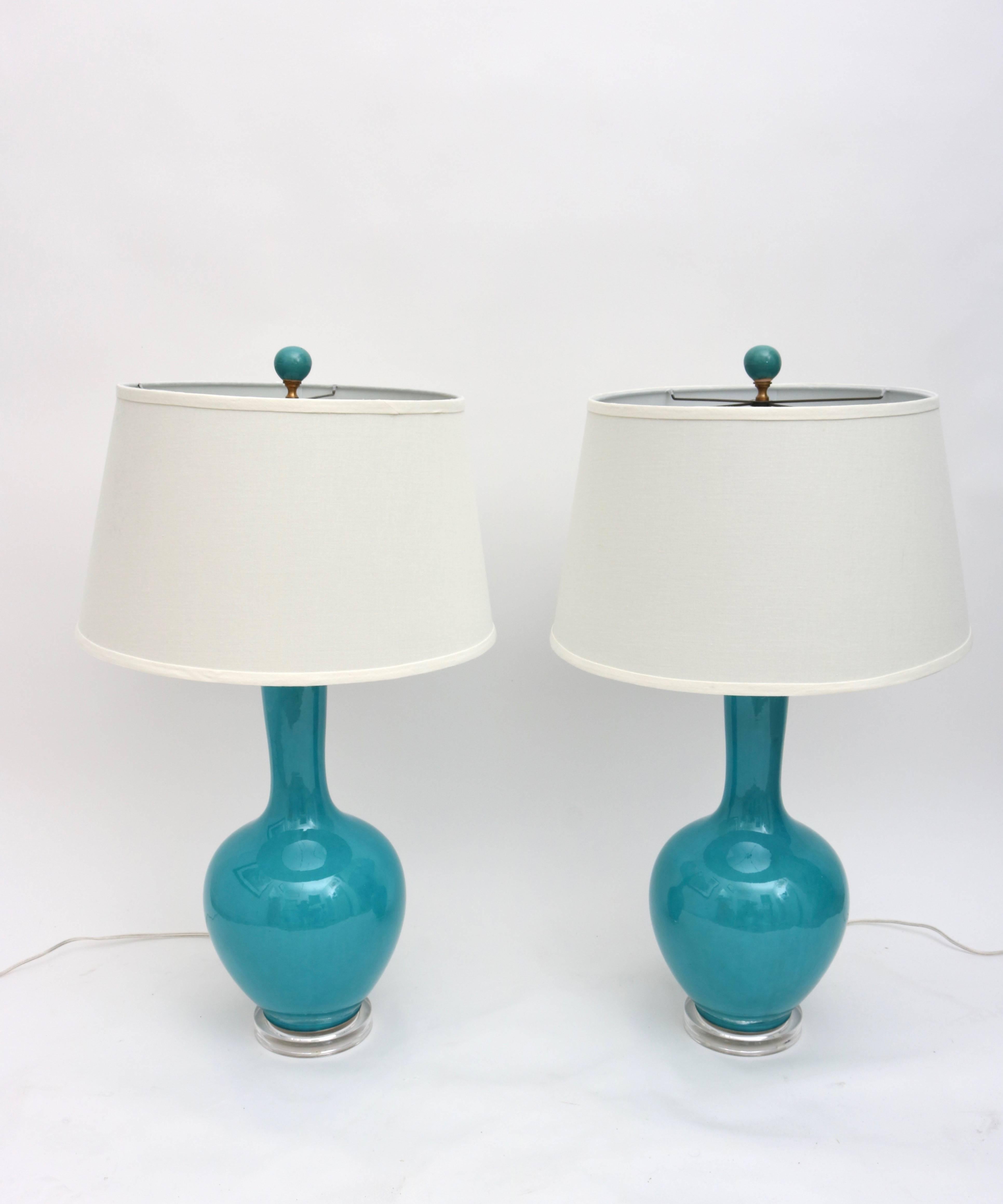 This stylish pair of table lamps in their glazed deep turquoise coloration will add that bit of sparkle to any room in your home.

Note: Shade is a hard-back in an off-white coloration.

Note: Overall height is 32.50